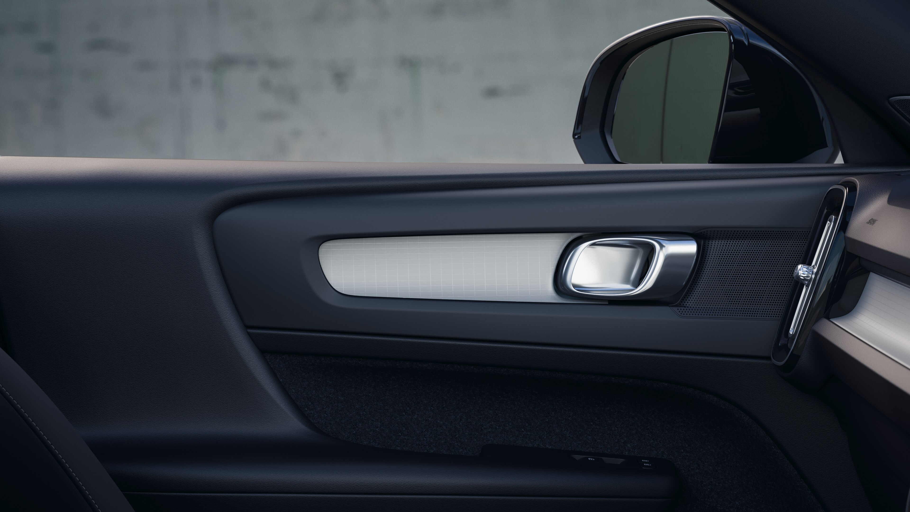 Volvo car interior showing front and rear passenger seats, steering wheel, dashboard, and center console against a plain studio background.