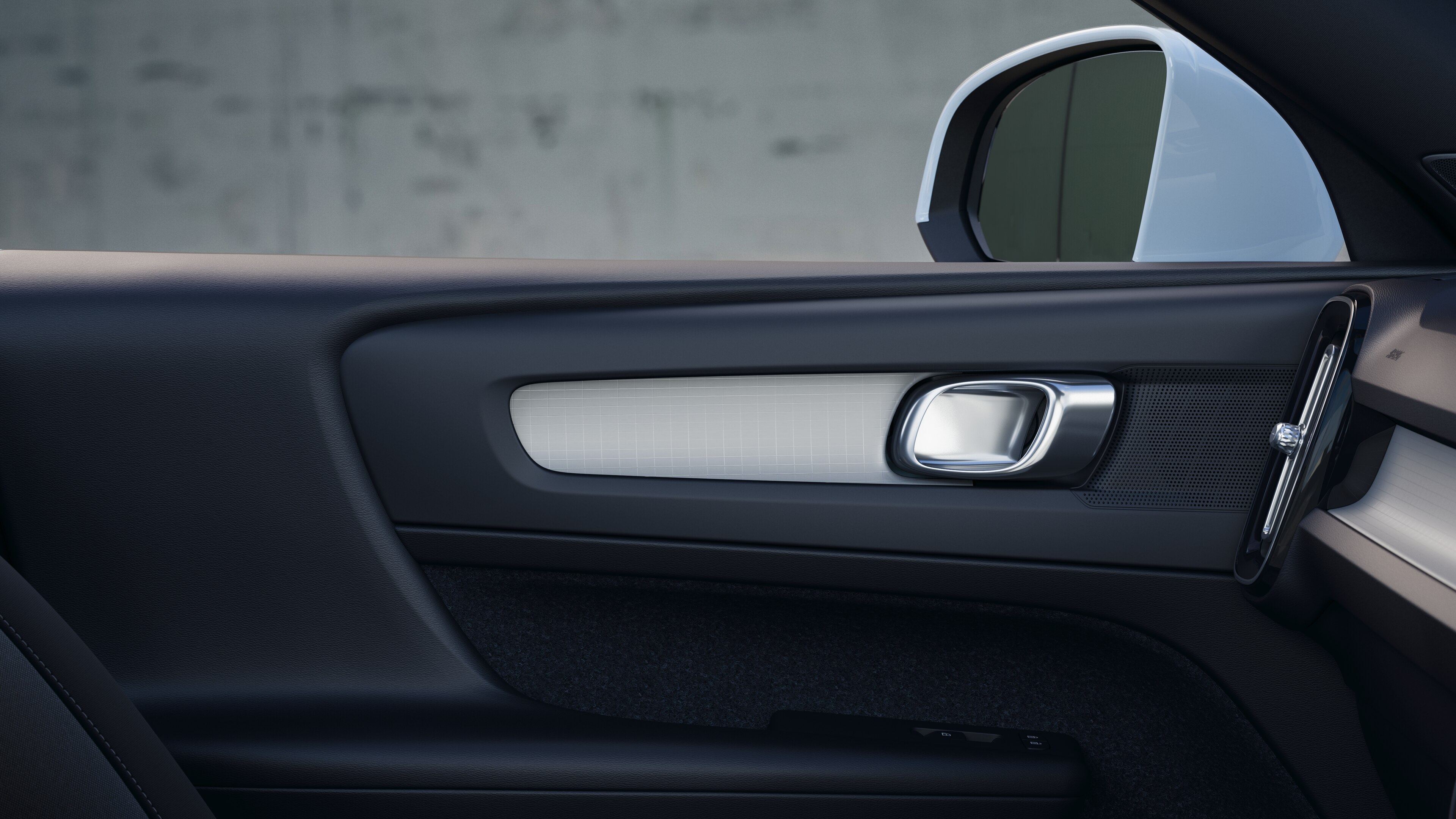 Volvo car interior showing front and rear passenger seats, steering wheel, dashboard, and center console against a plain studio background.