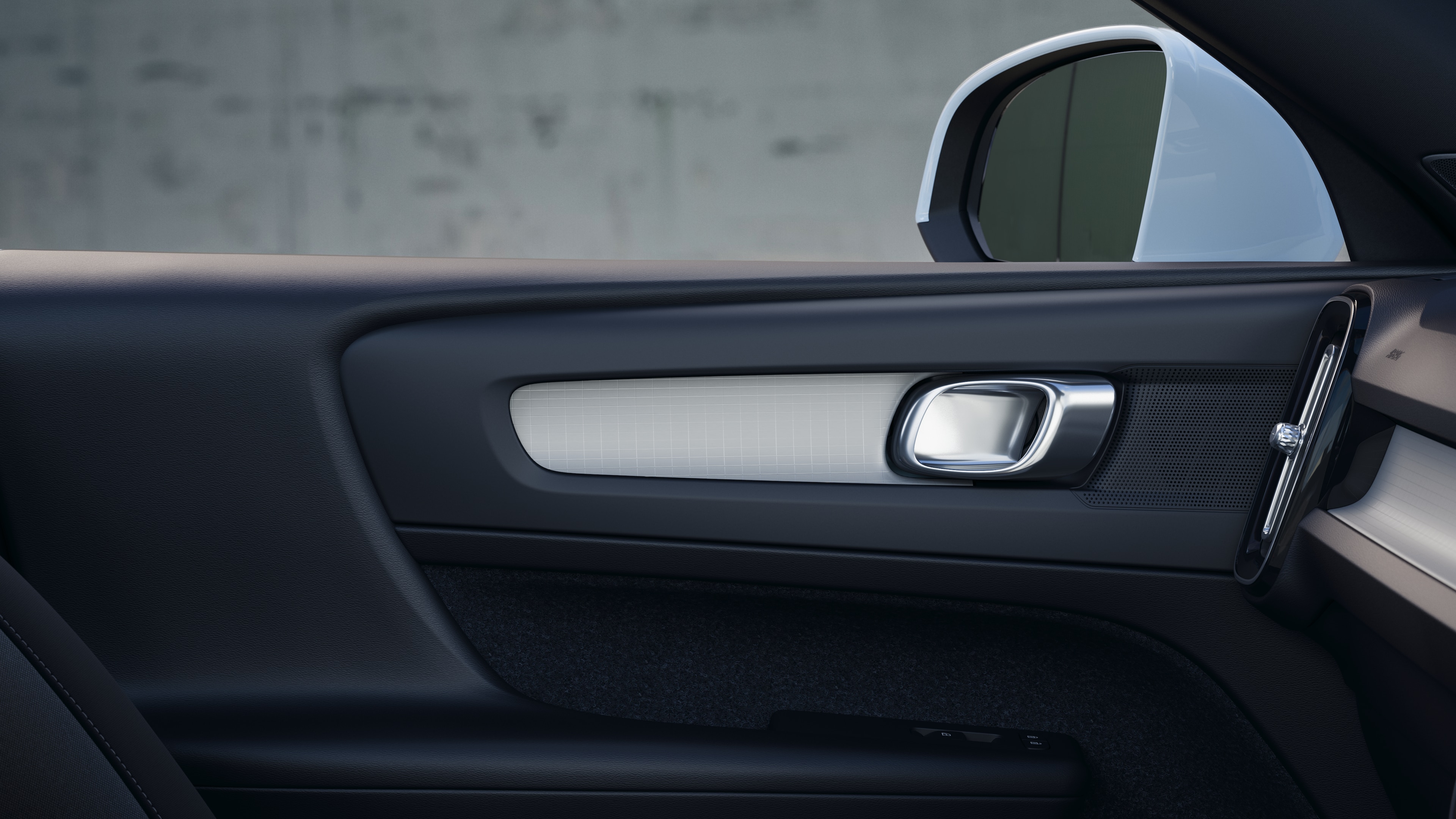 Volvo car interior showing front and rear passenger seats, steering wheel, dashboard, and center console against a plain studio background.