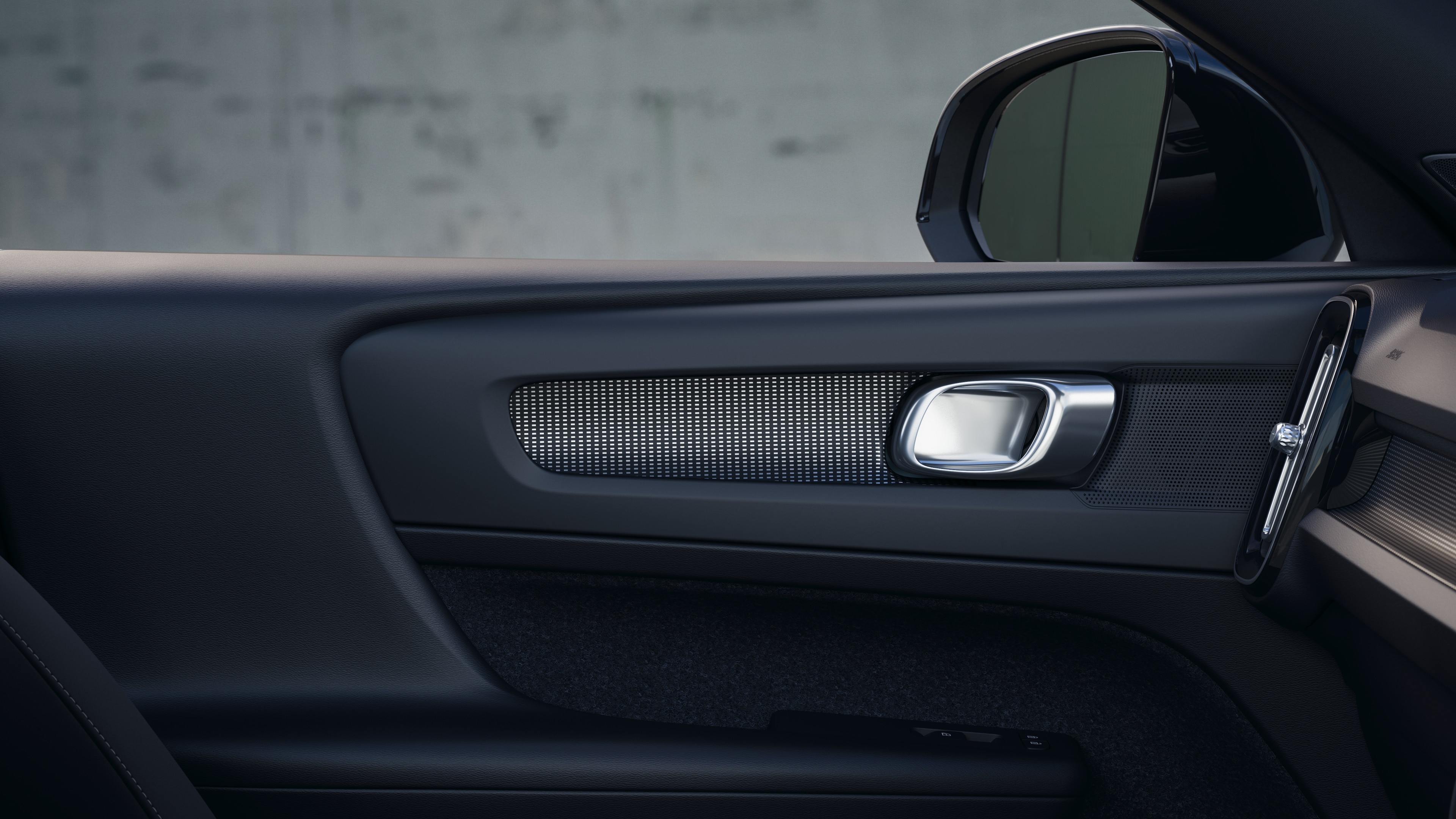 Volvo car interior showing front and rear passenger seats, steering wheel, dashboard, and center console against a plain studio background.