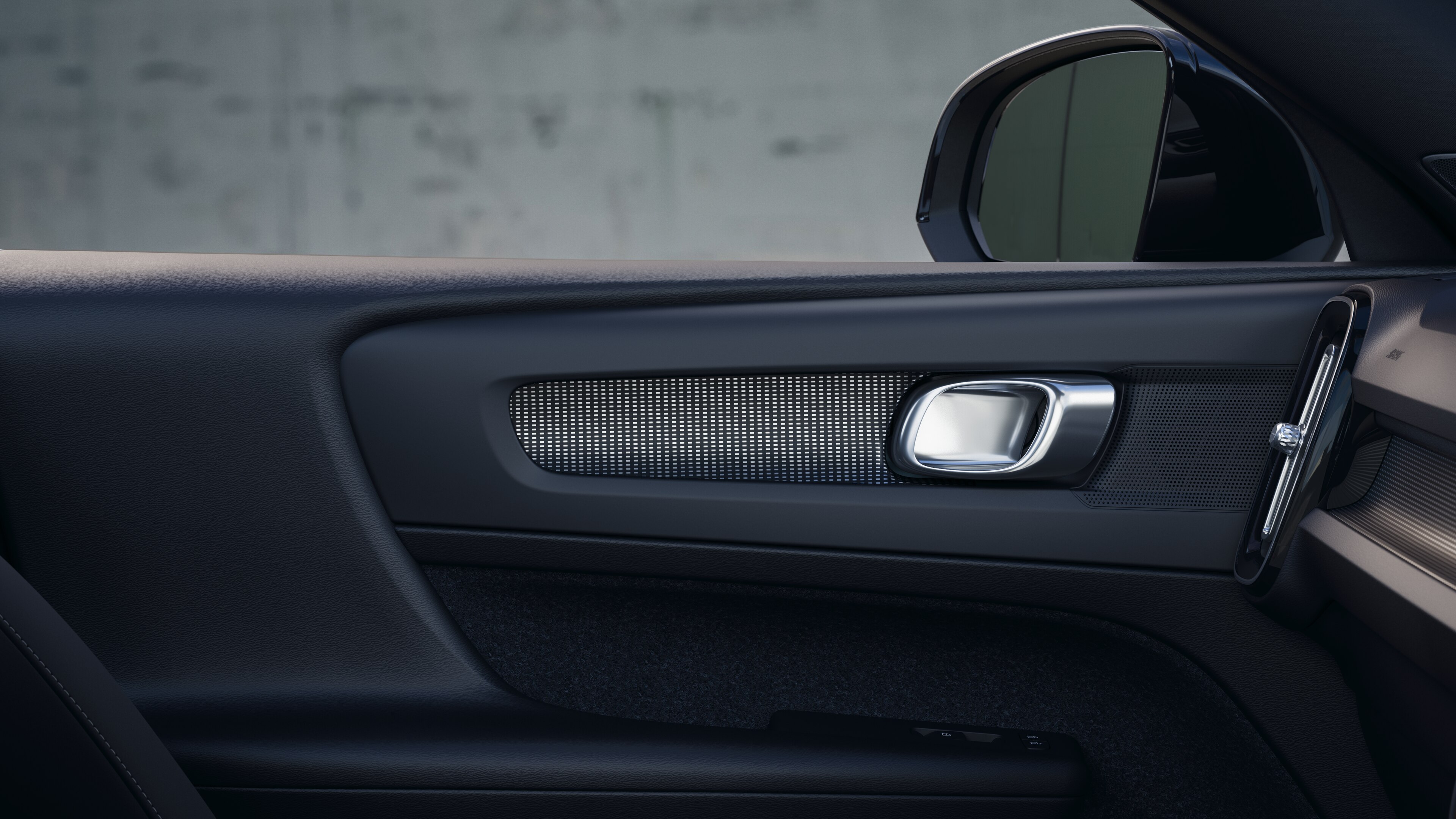 Volvo car interior showing front and rear passenger seats, steering wheel, dashboard, and center console against a plain studio background.