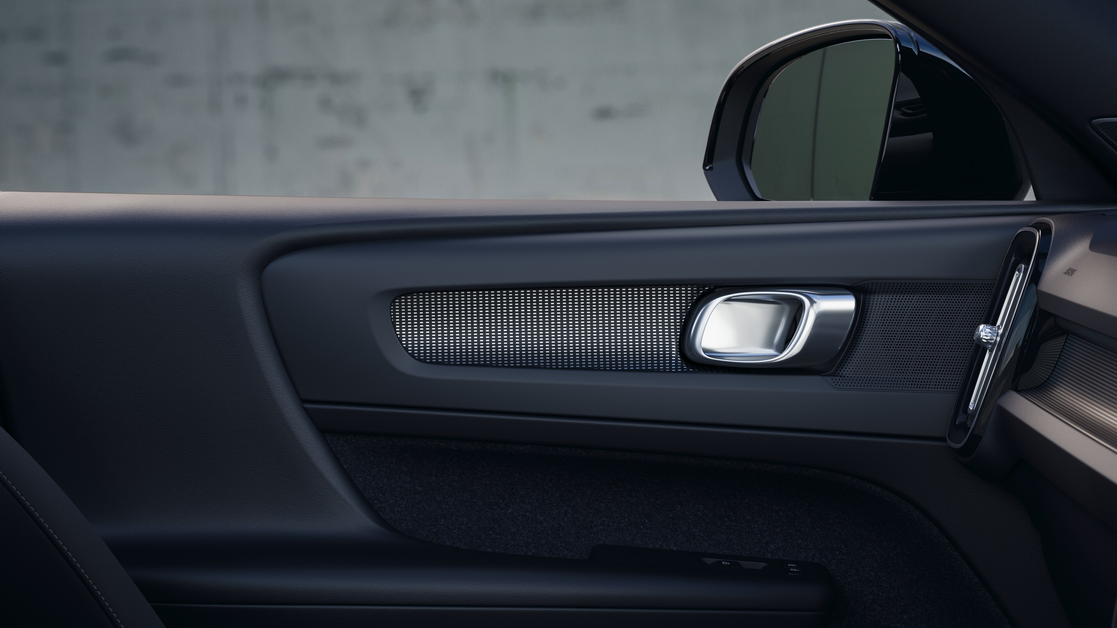 Volvo car interior showing front and rear passenger seats, steering wheel, dashboard, and center console against a plain studio background.