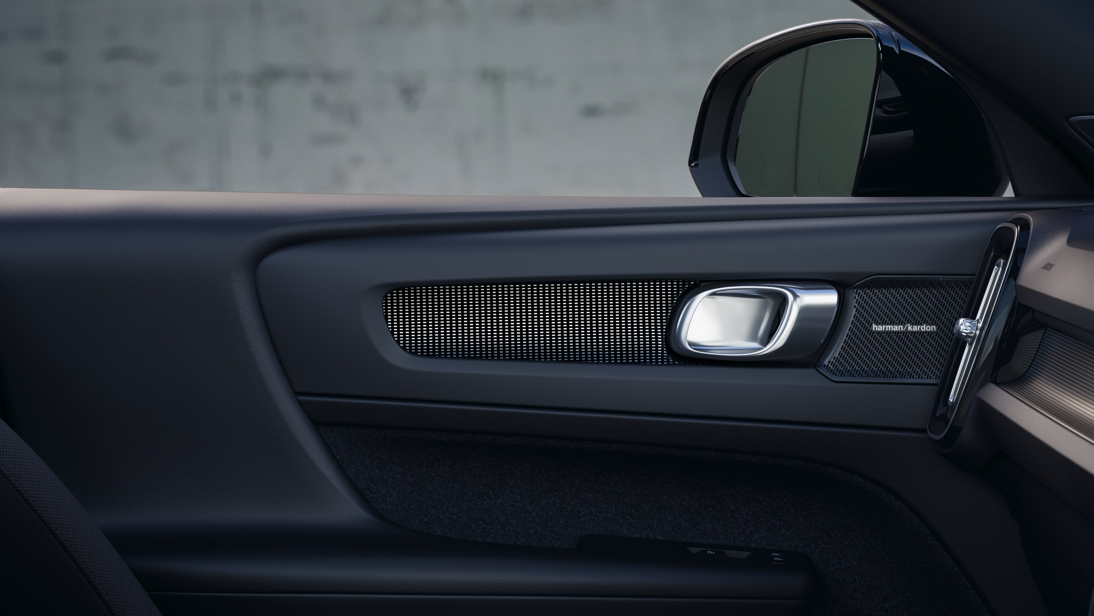 Volvo car interior showing front and rear passenger seats, steering wheel, dashboard, and center console against a plain studio background.