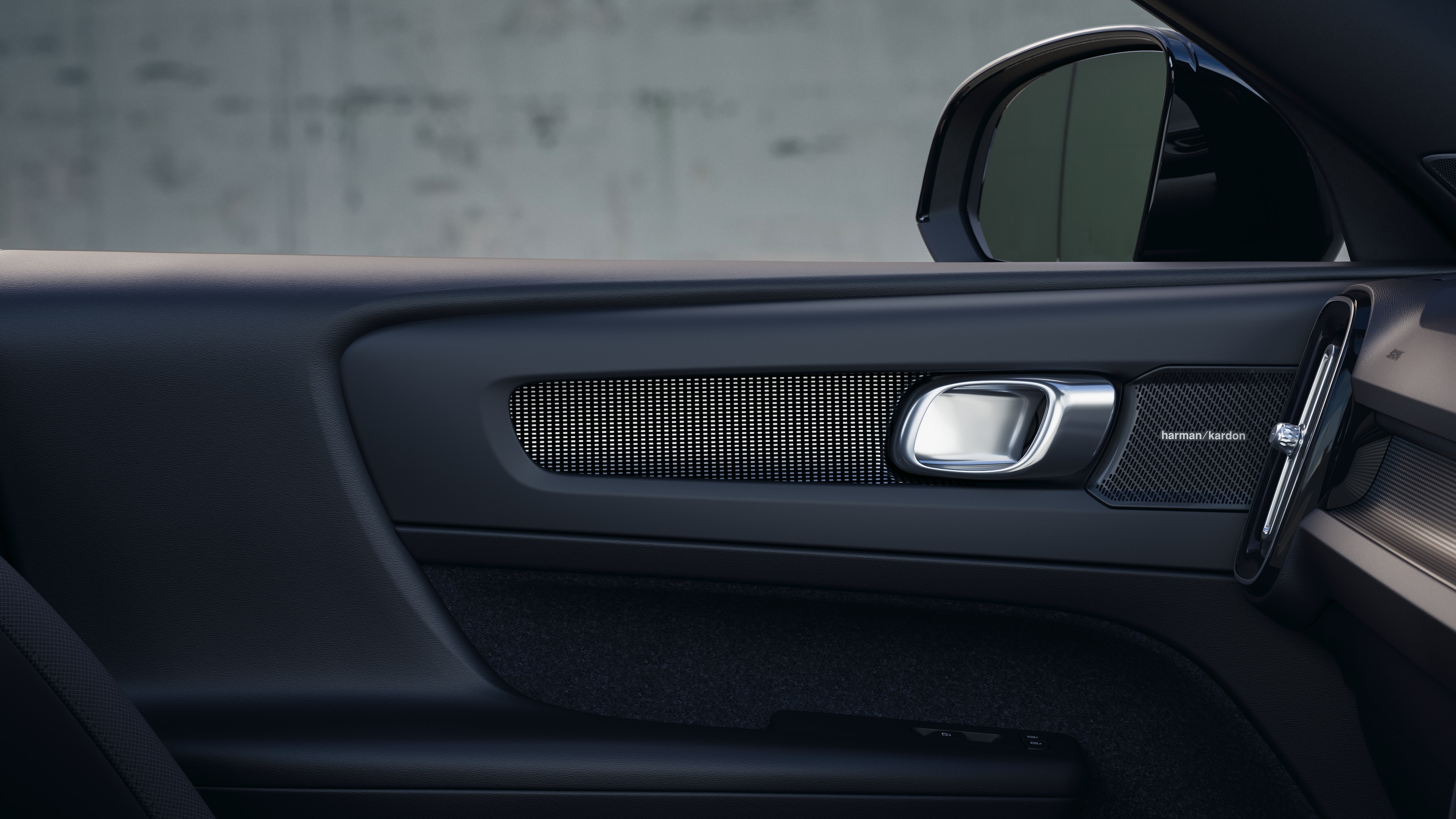 Volvo car interior showing front and rear passenger seats, steering wheel, dashboard, and center console against a plain studio background.