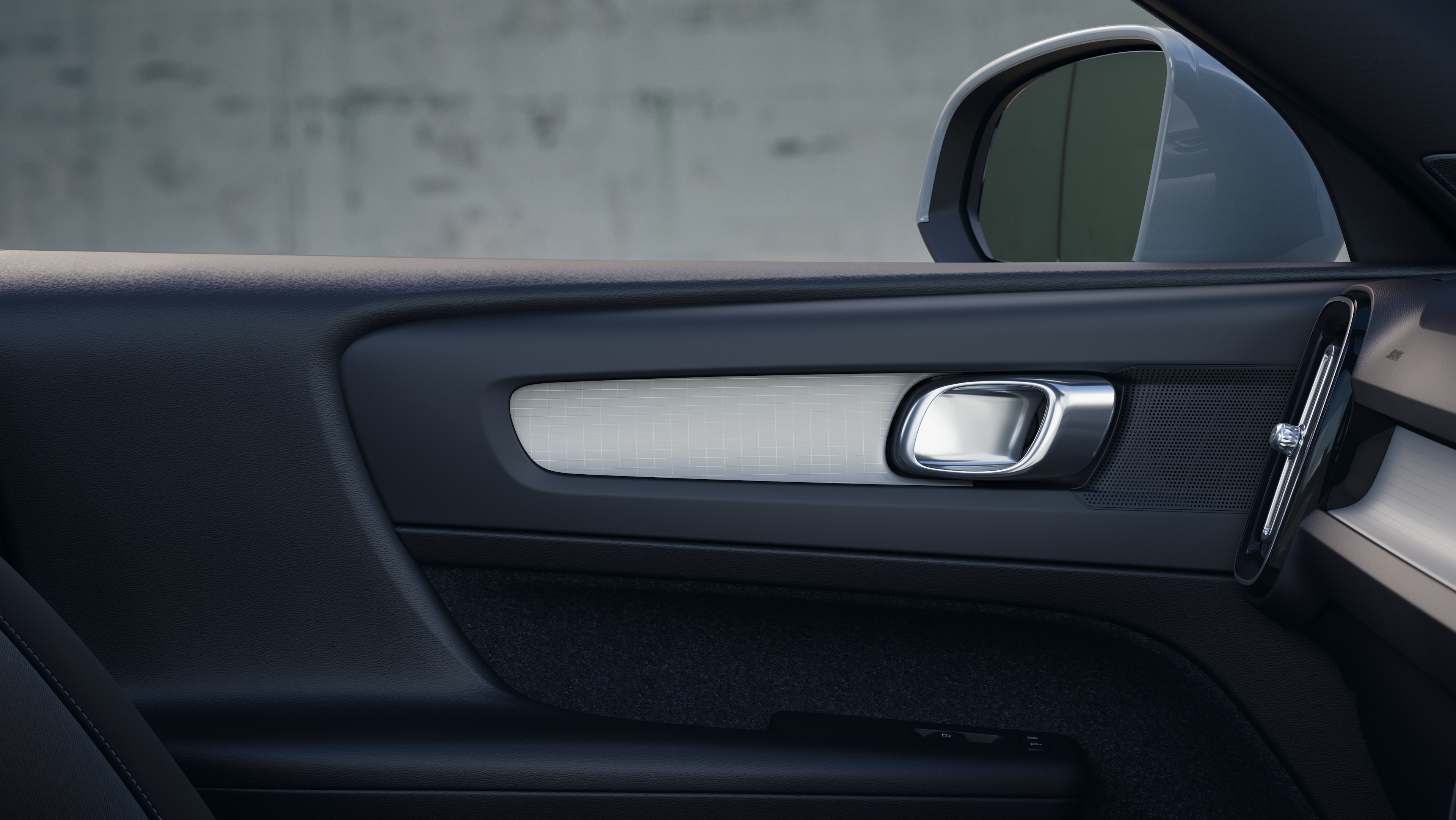 Volvo car interior showing front and rear passenger seats, steering wheel, dashboard, and center console against a plain studio background.