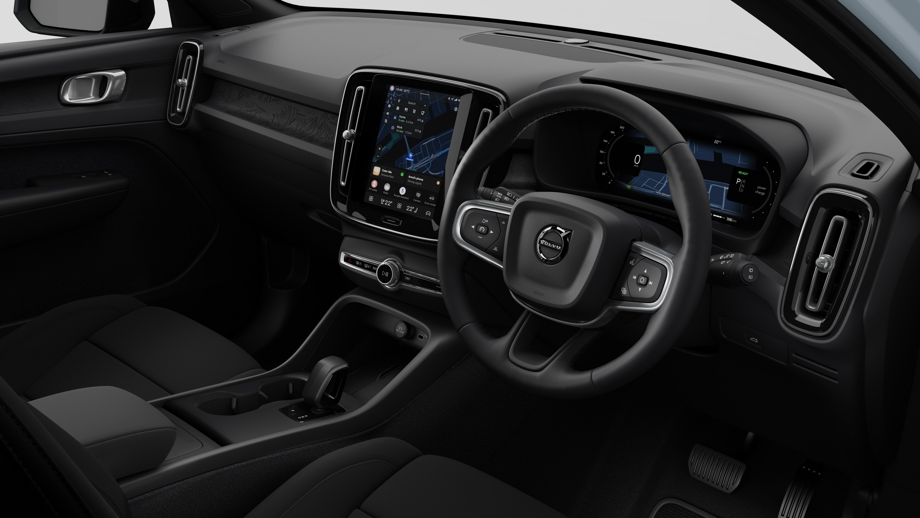 Interior view of a Volvo car showing the dashboard, steering wheel, center console, and digital display screen in a plain studio background.