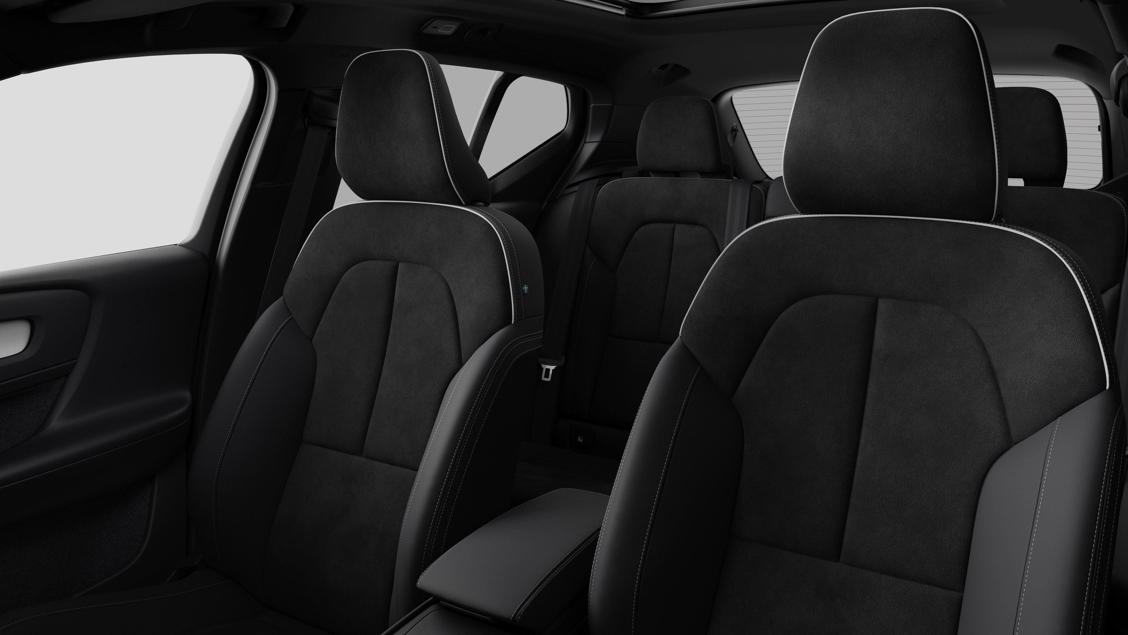 Volvo car interior showing rear passenger seats and center console in plain studio background.
