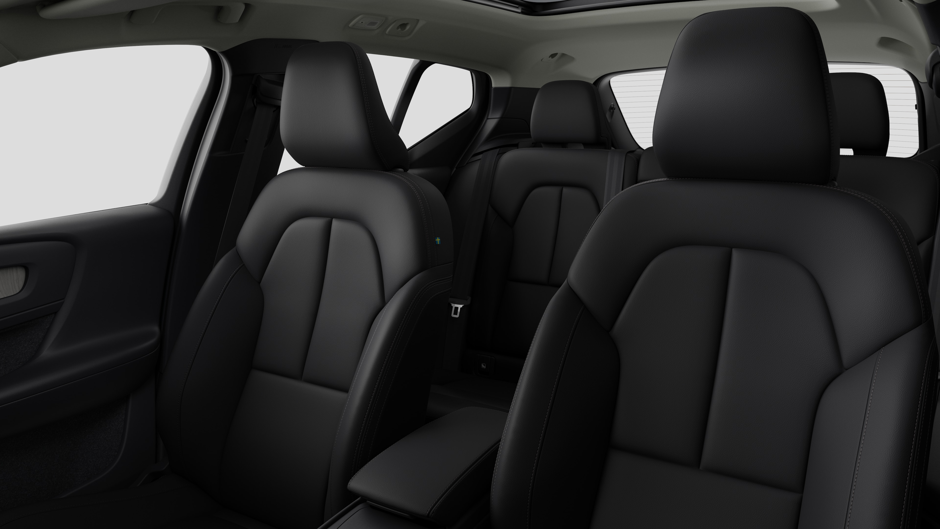 Intérieur d’une Volvo montrant les sièges passager arrière et la console centrale en arrière-plan de studio.