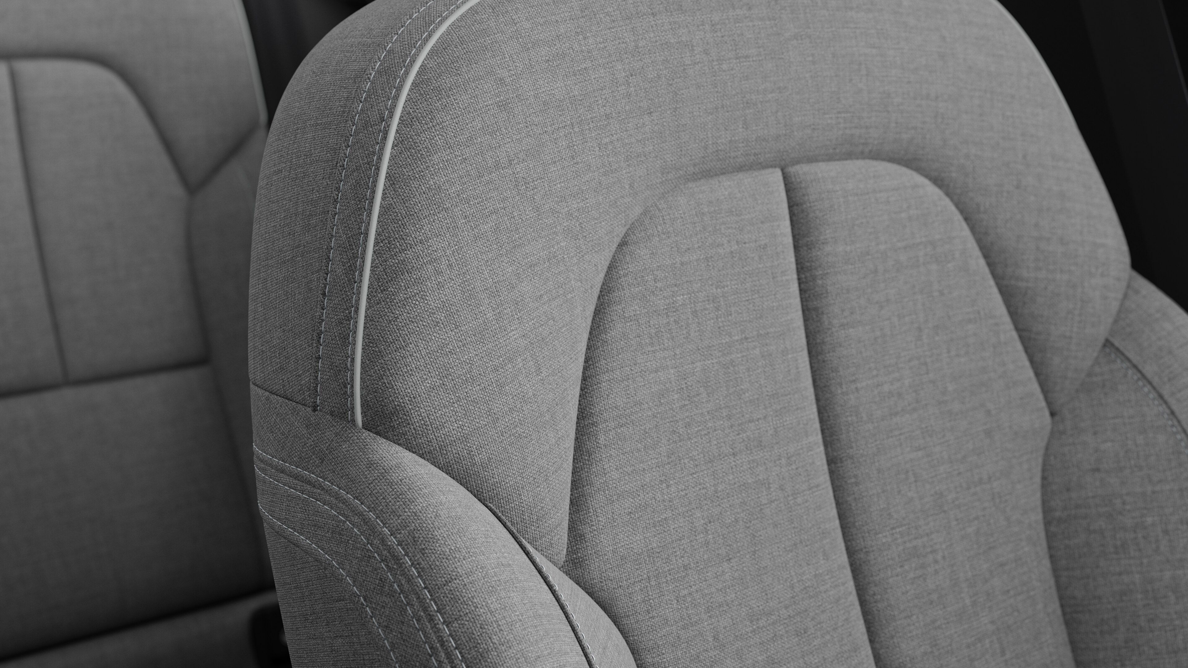 ステッチと小さなスウェーデン国旗のタグが付いたボルボ車のインテリアシートのディテールのクローズアップ。