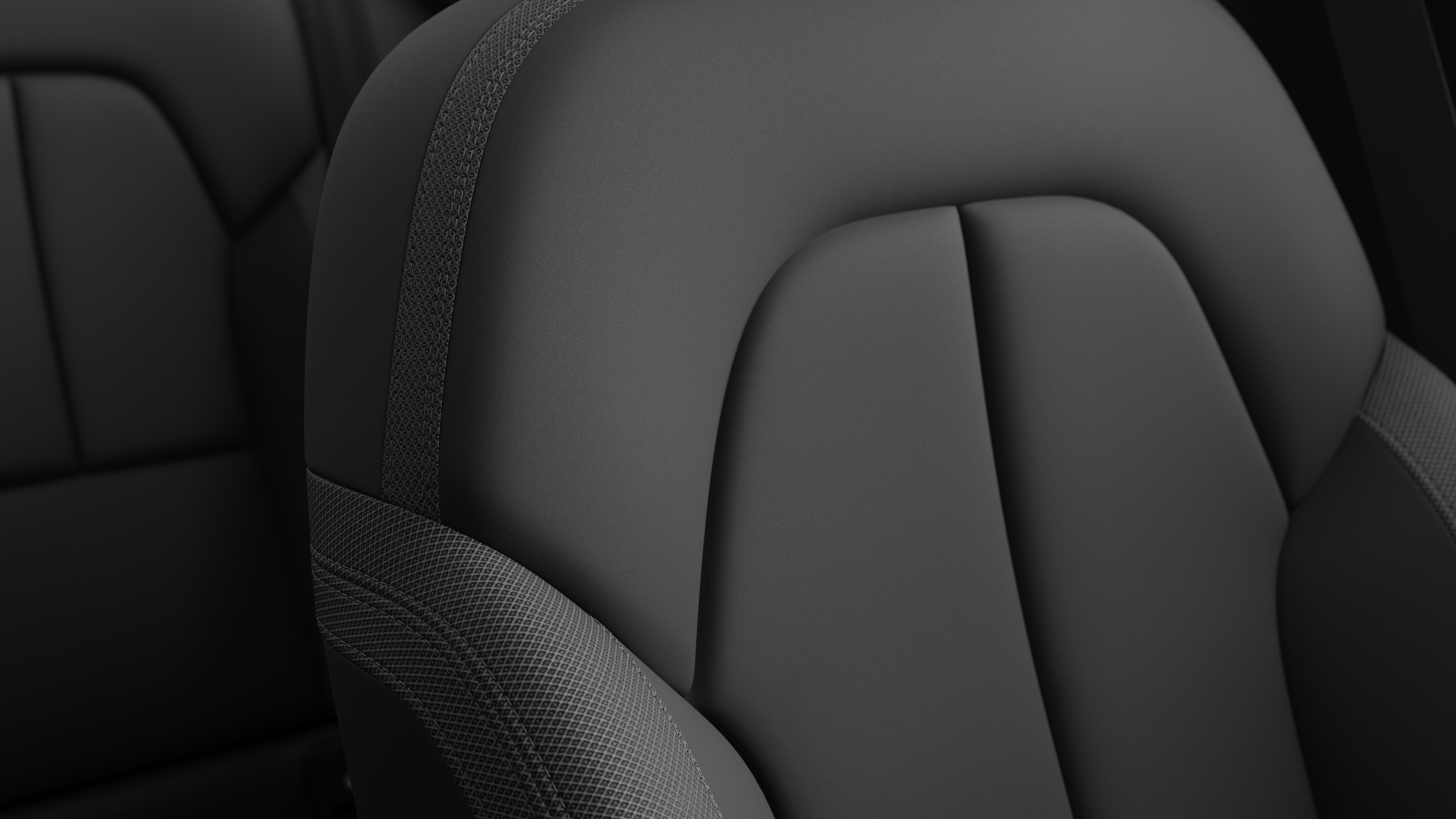 Close-up of Volvo car interior seat detail showing stitching and a small Swedish flag tag.