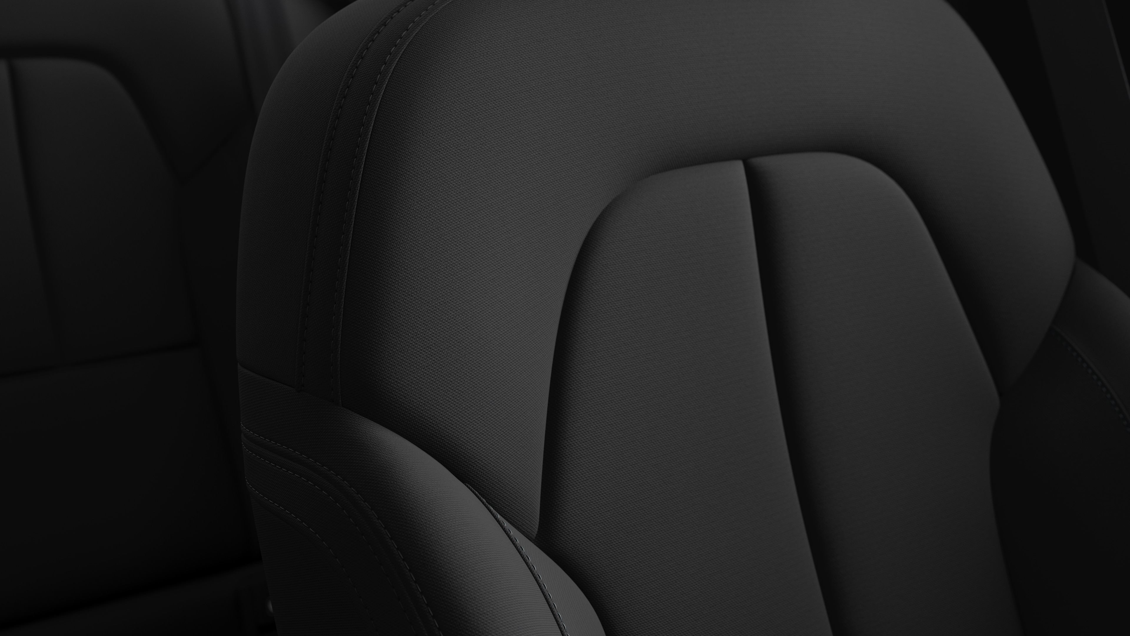 Close-up of Volvo car interior seat detail showing stitching and a small Swedish flag tag.