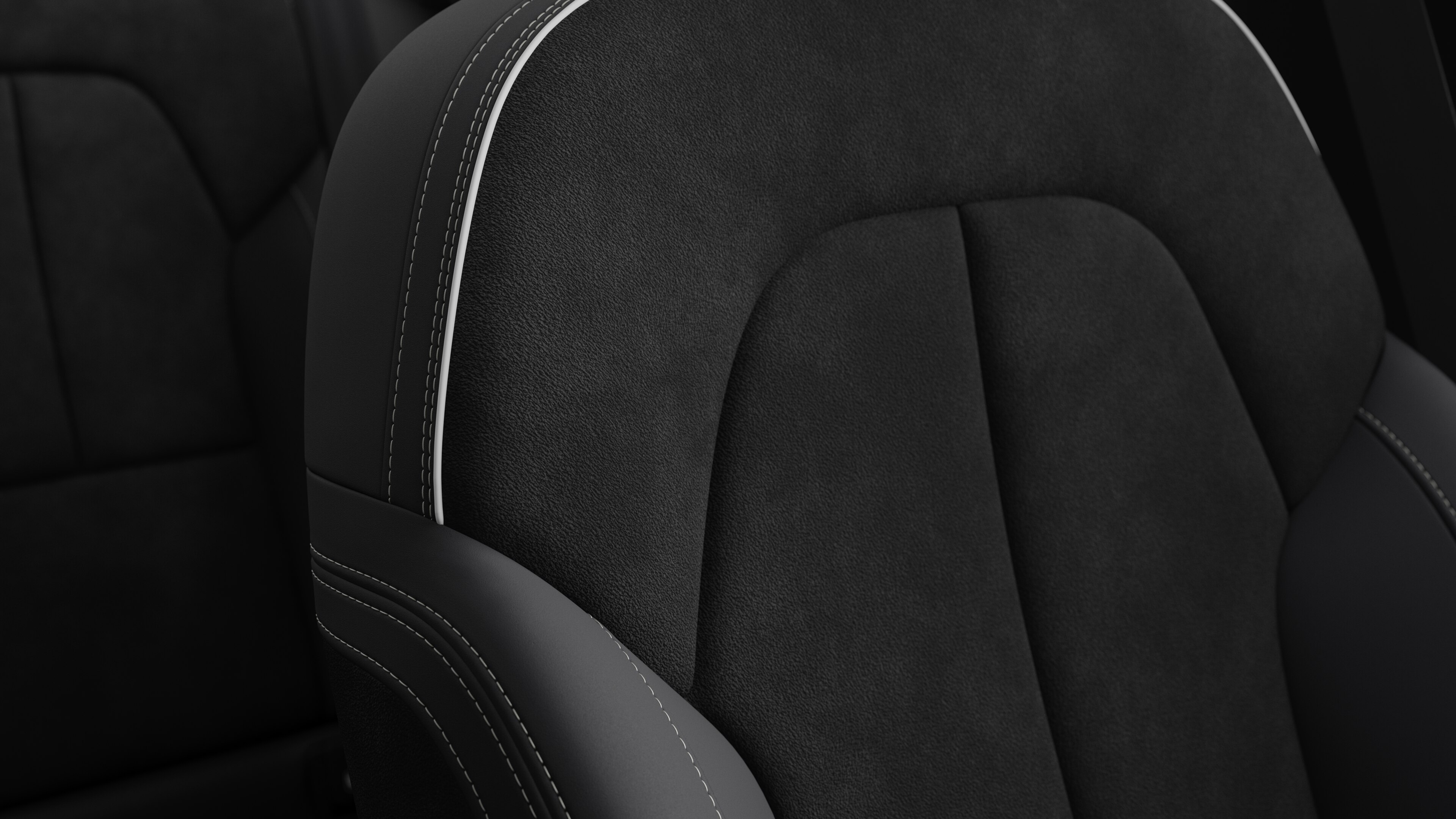 Close-up of Volvo car interior seat detail showing stitching and a small Swedish flag tag.