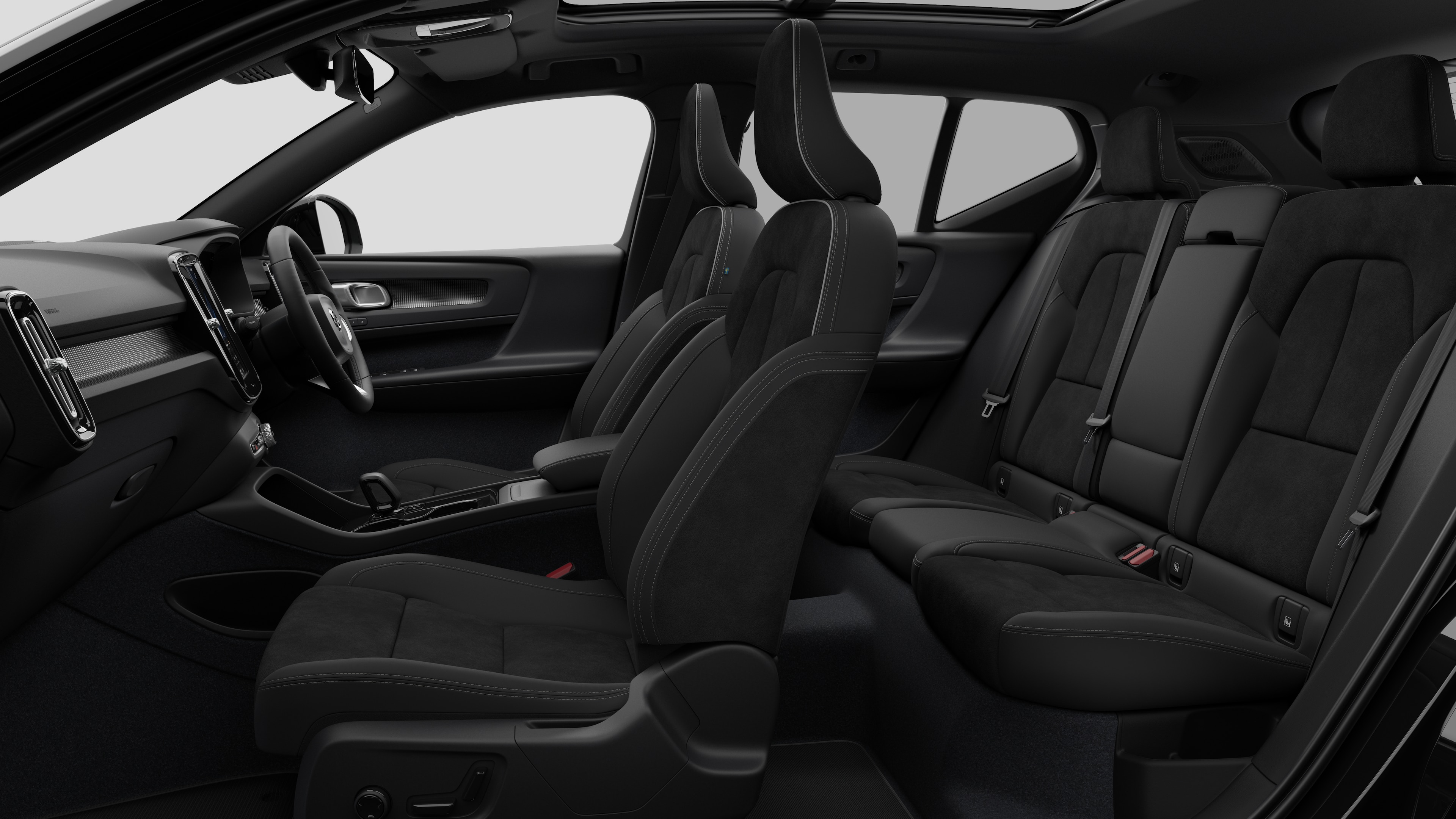 Volvo car interior side view showcasing front seats, rear passenger seats, steering wheel, dashboard, and centre console, set against plain studio background.