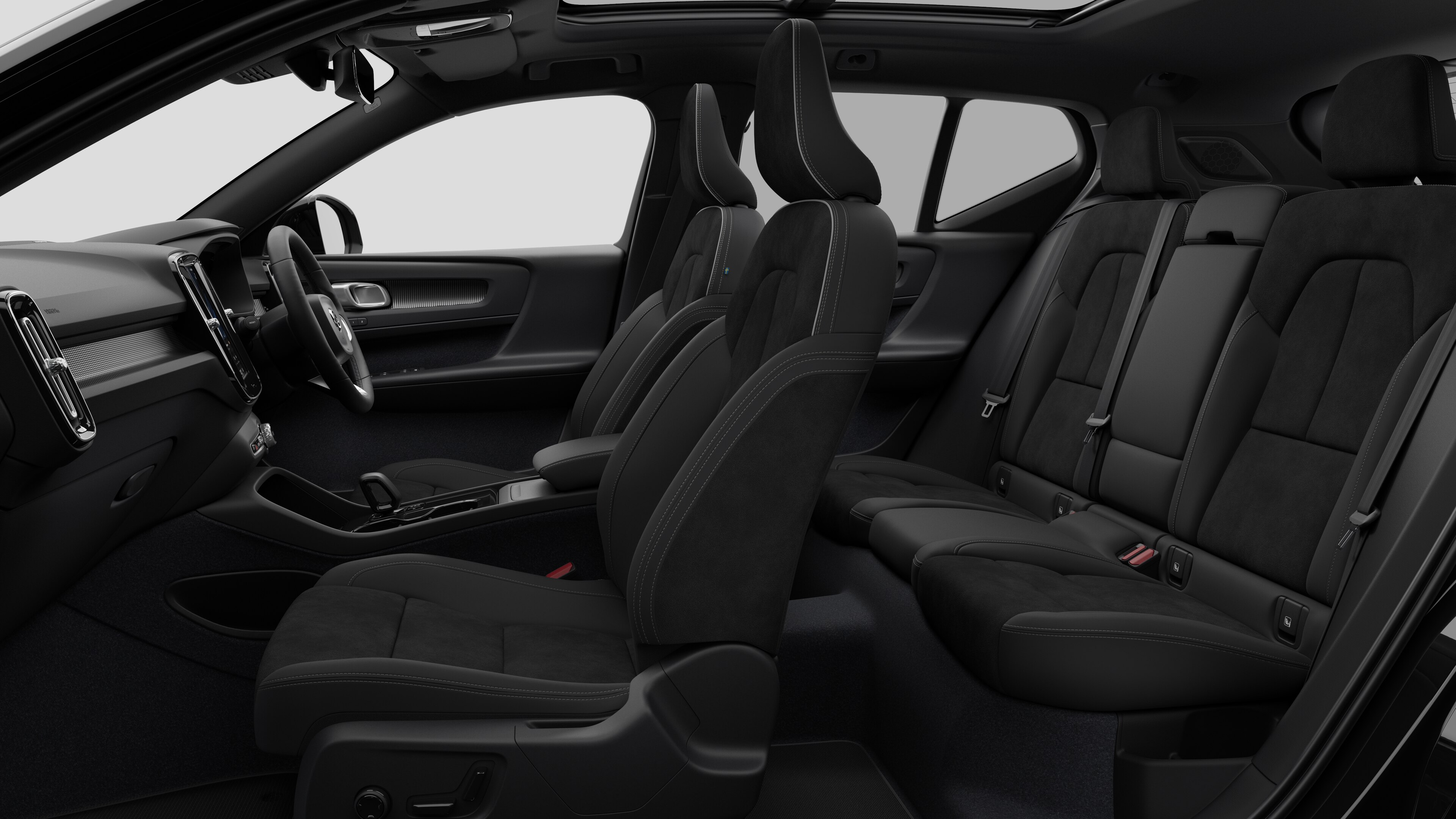 Volvo car interior side view showcasing front seats, rear passenger seats, steering wheel, dashboard, and centre console, set against plain studio background.