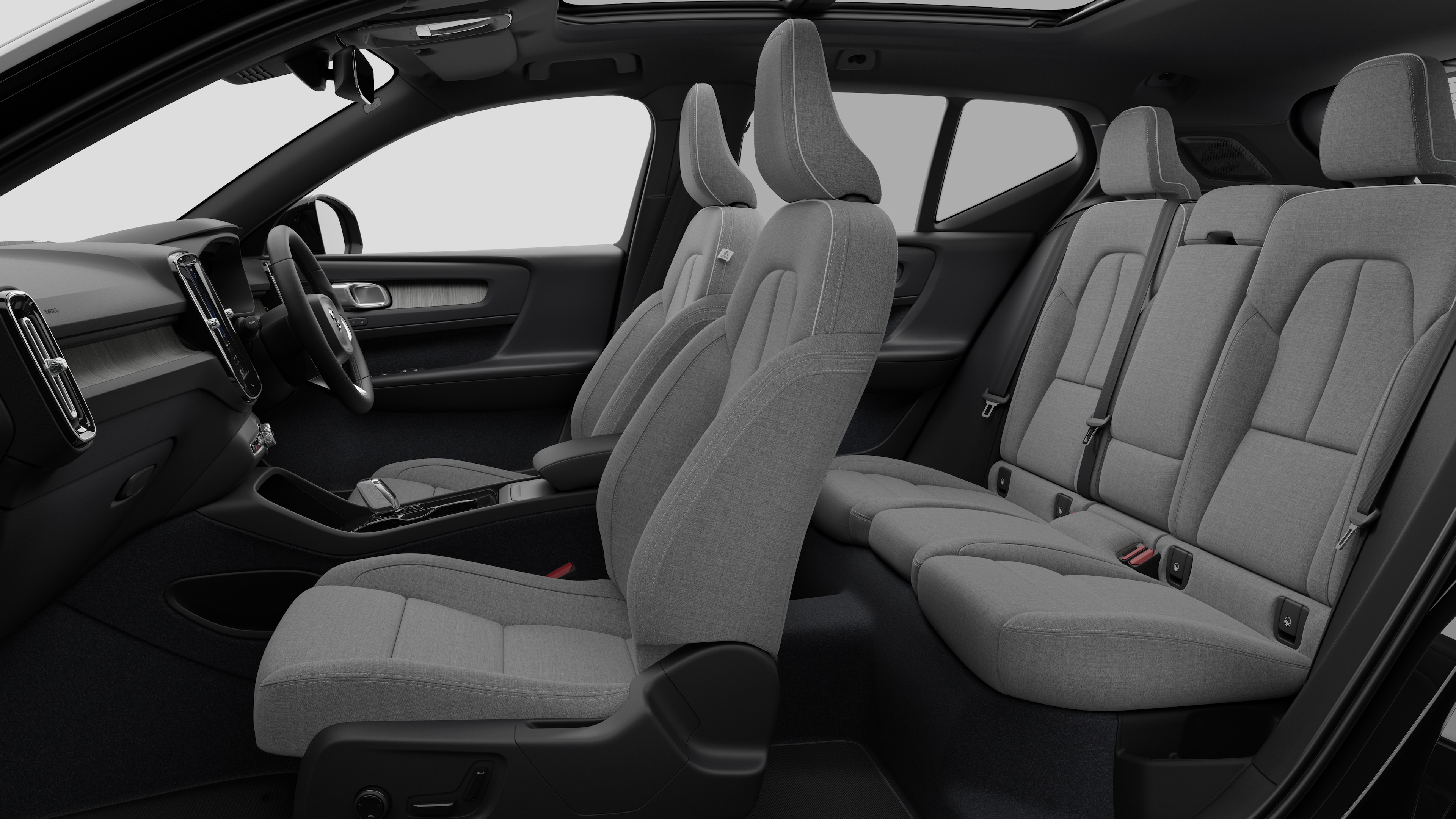 Volvo car interior side view showcasing front seats, rear passenger seats, steering wheel, dashboard, and center console, set against plain studio background.