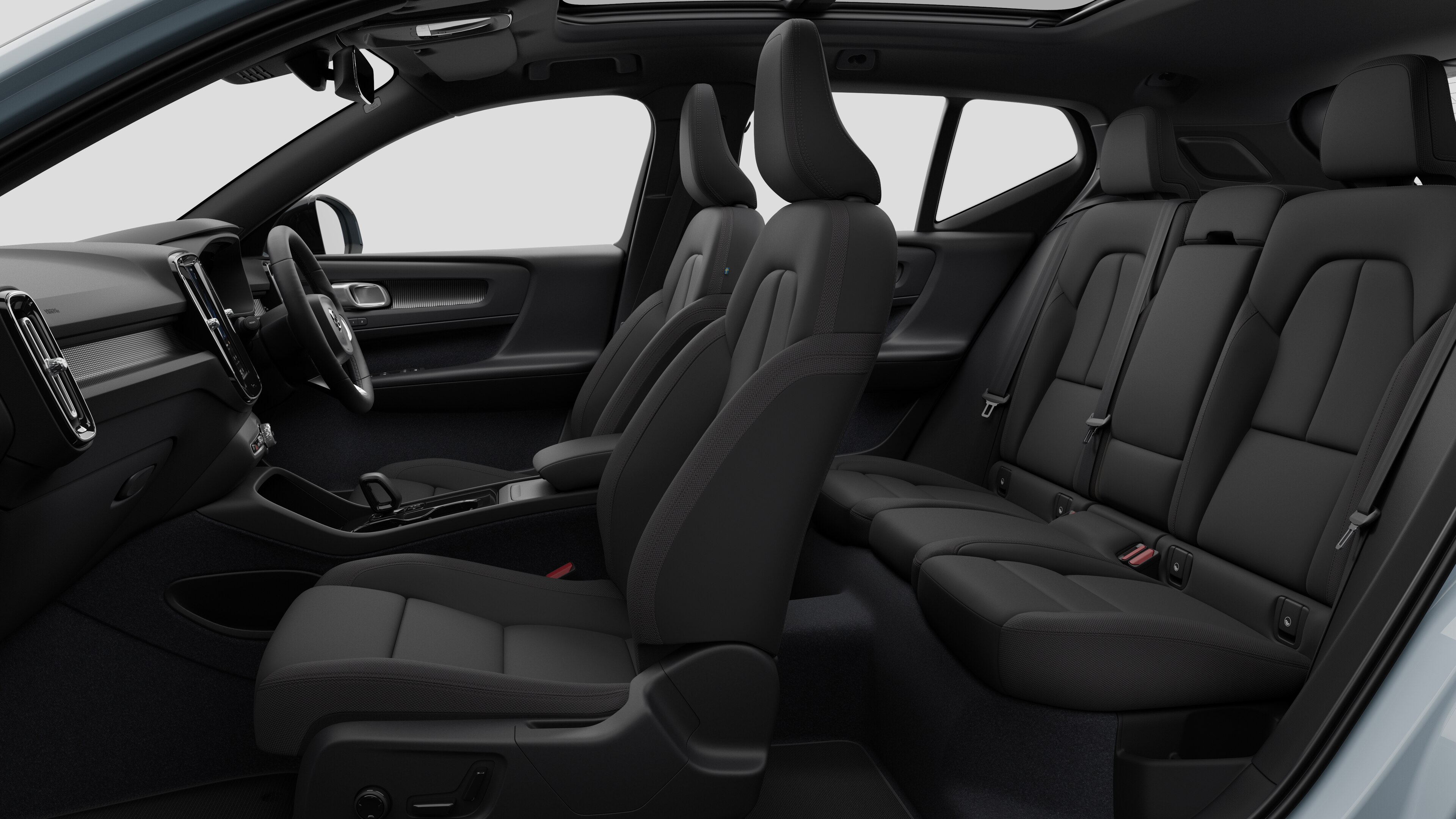 Volvo car interior side view showcasing front seats, rear passenger seats, steering wheel, dashboard, and center console, set against plain studio background.