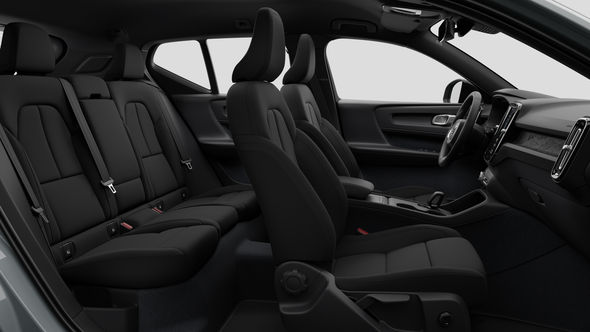 Vue latérale de l’intérieur d’une Volvo montrant les sièges avant, les sièges passager arrière, le volant, le tableau de bord et la console centrale, sur fond de studio.