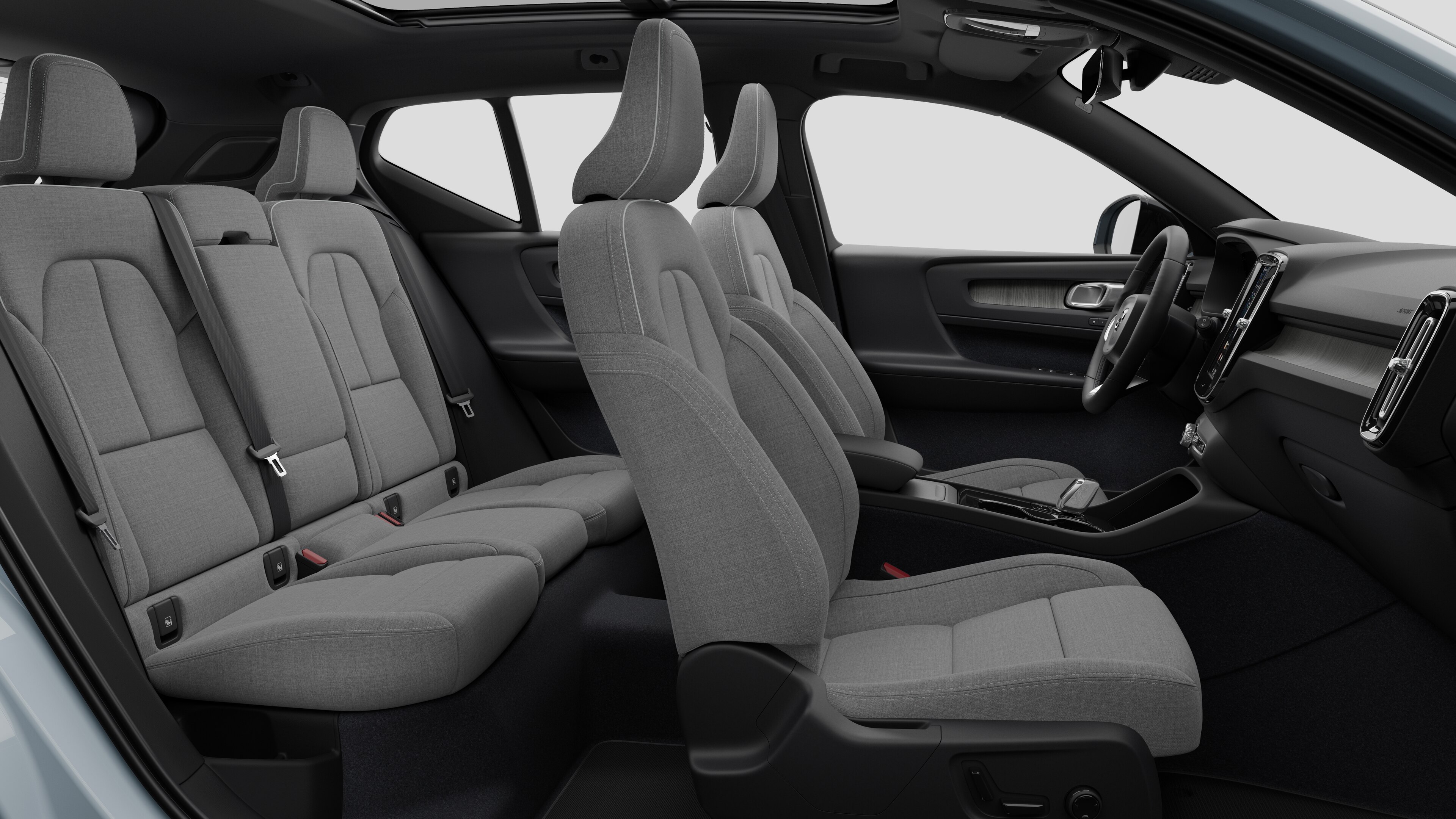 Volvo car interior side view showcasing front seats, rear passenger seats, steering wheel, dashboard, and center console, set against plain studio background.