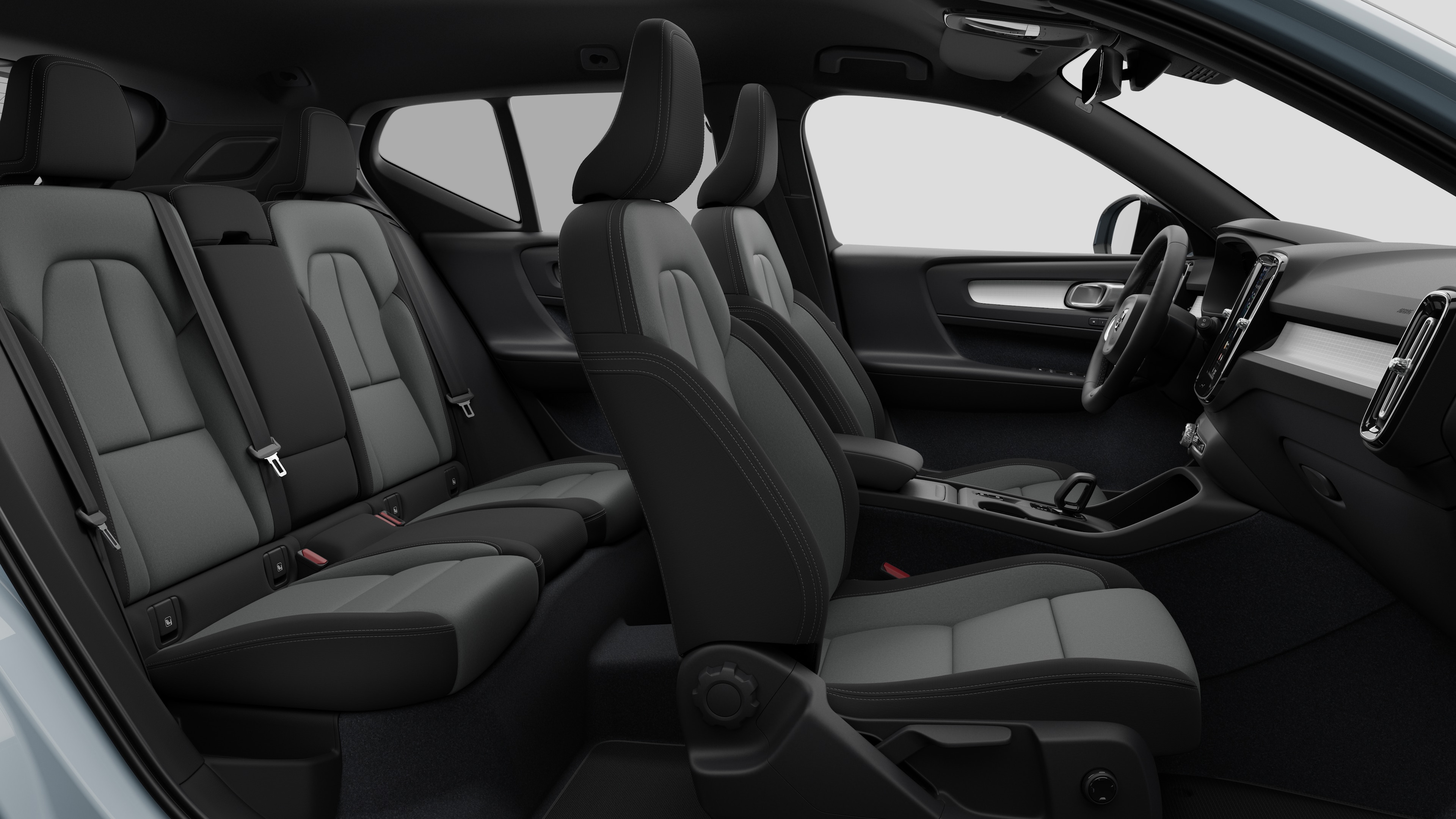 Volvo car interior side view showcasing front seats, rear passenger seats, steering wheel, dashboard, and center console, set against plain studio background.