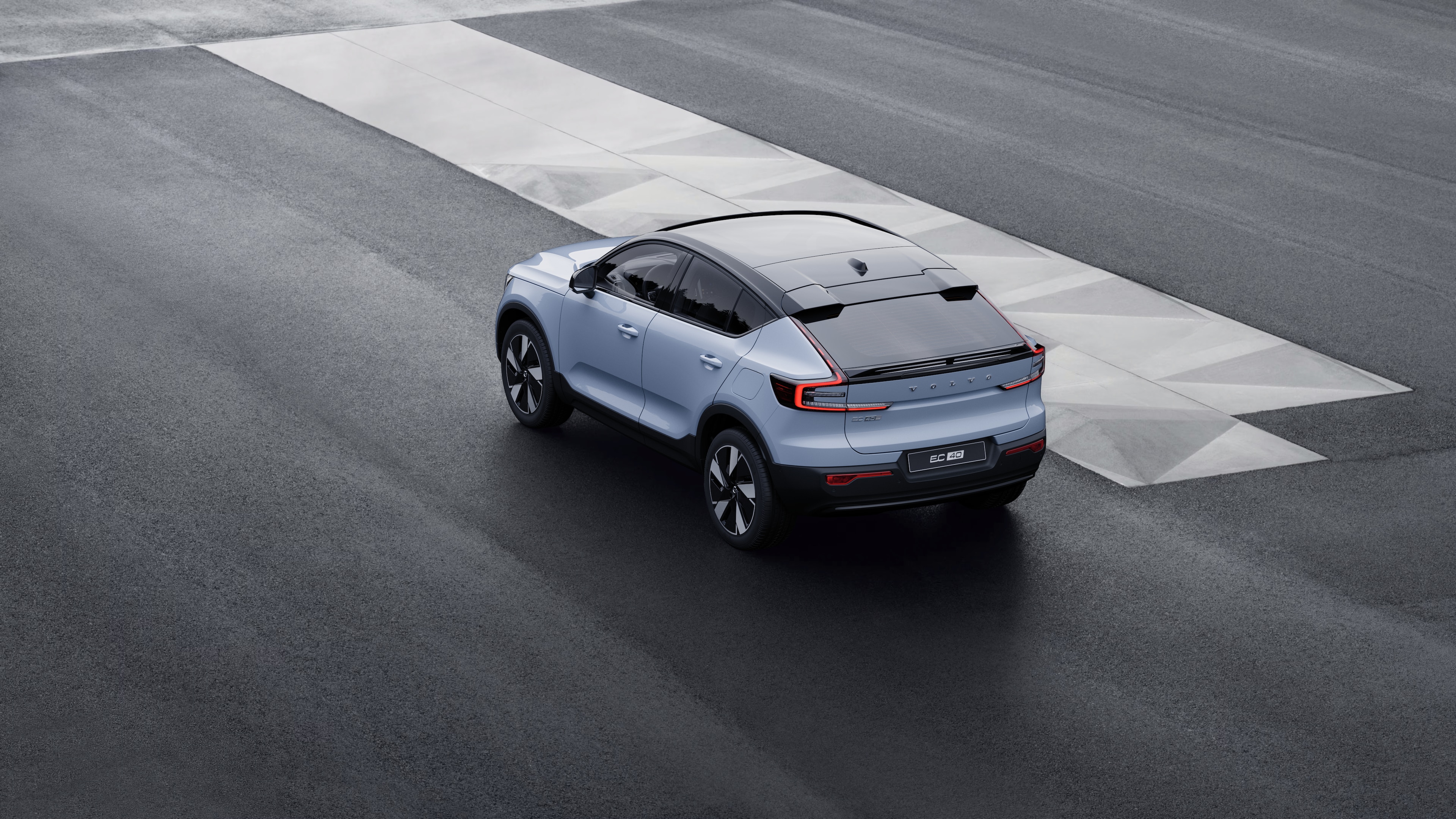 Volvo-bil bagi trekvartbillede parkeret mod en betonvæg på en bygadebaggrund.