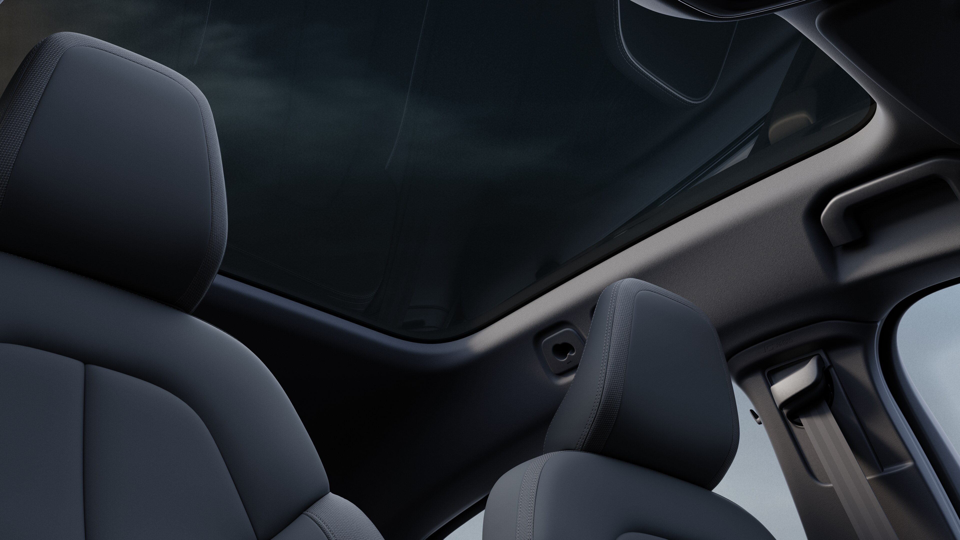 Volvo car interior showing front and rear passenger seats, steering wheel, dashboard, and center console against a plain studio background.