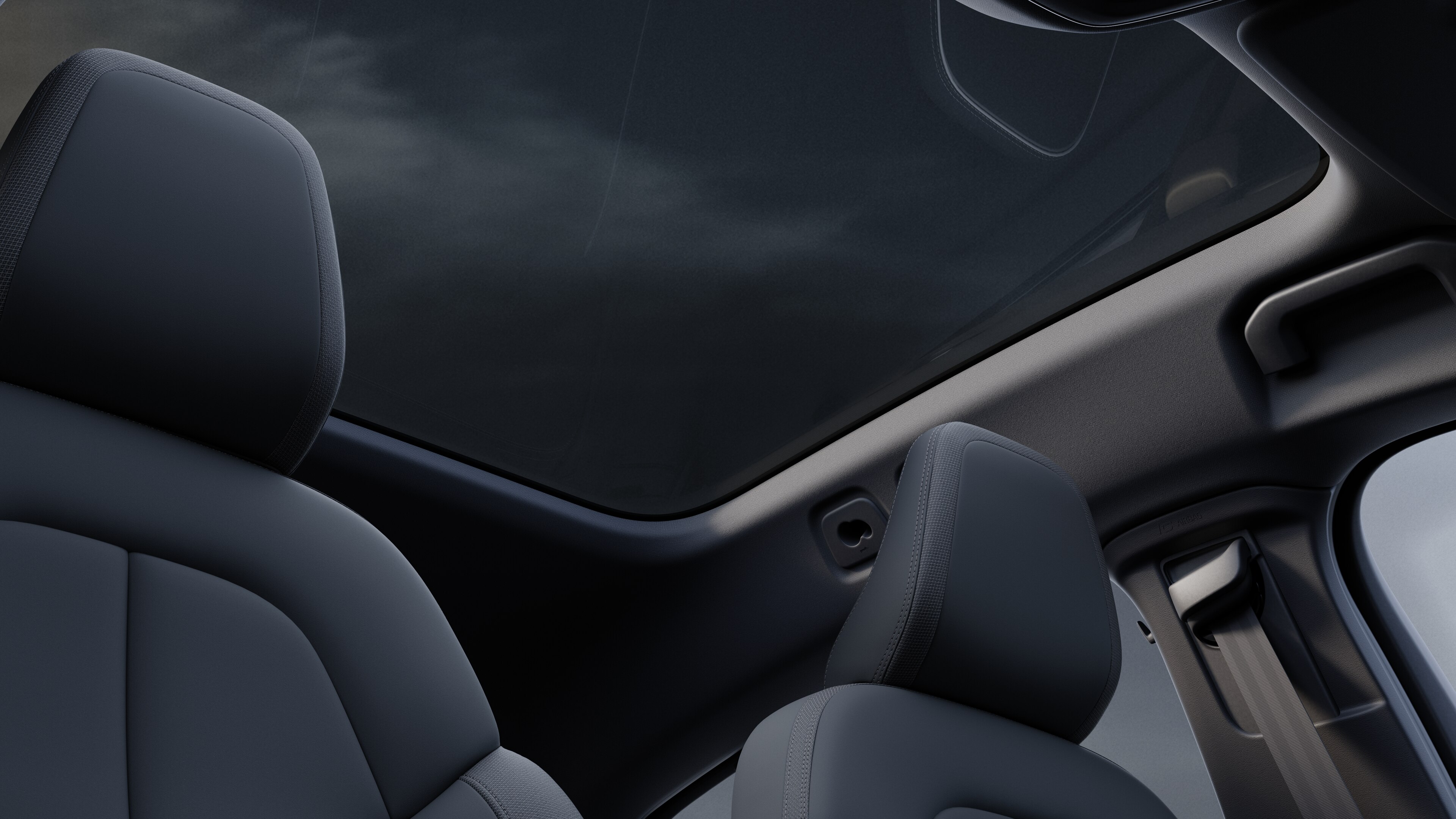 Volvo car interior showing front and rear passenger seats, steering wheel, dashboard, and center console against a plain studio background.