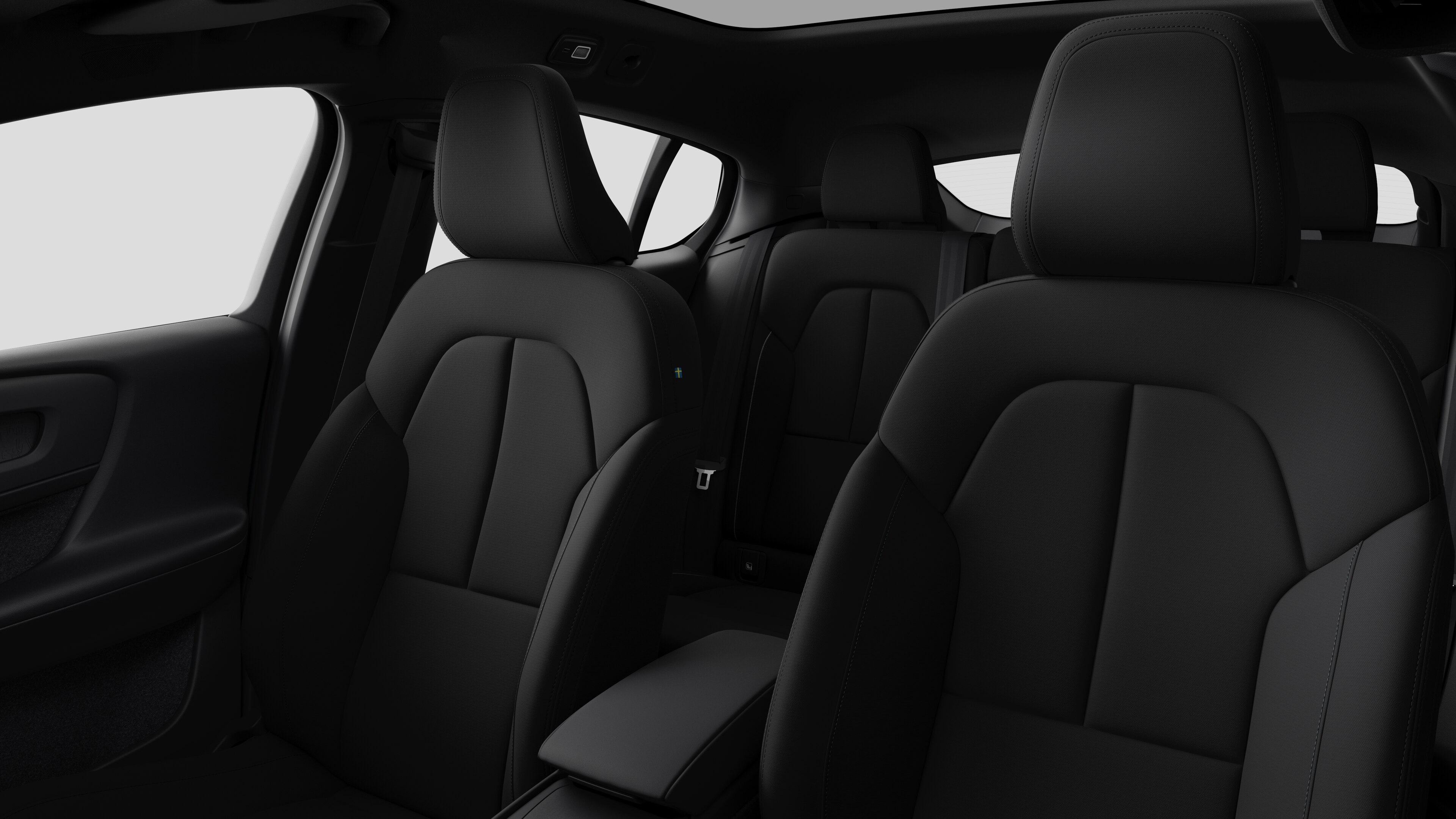 Wnętrze samochodu Volvo z tylnymi siedzeniami pasażerów i konsolą środkową na tle zwykłego studia.