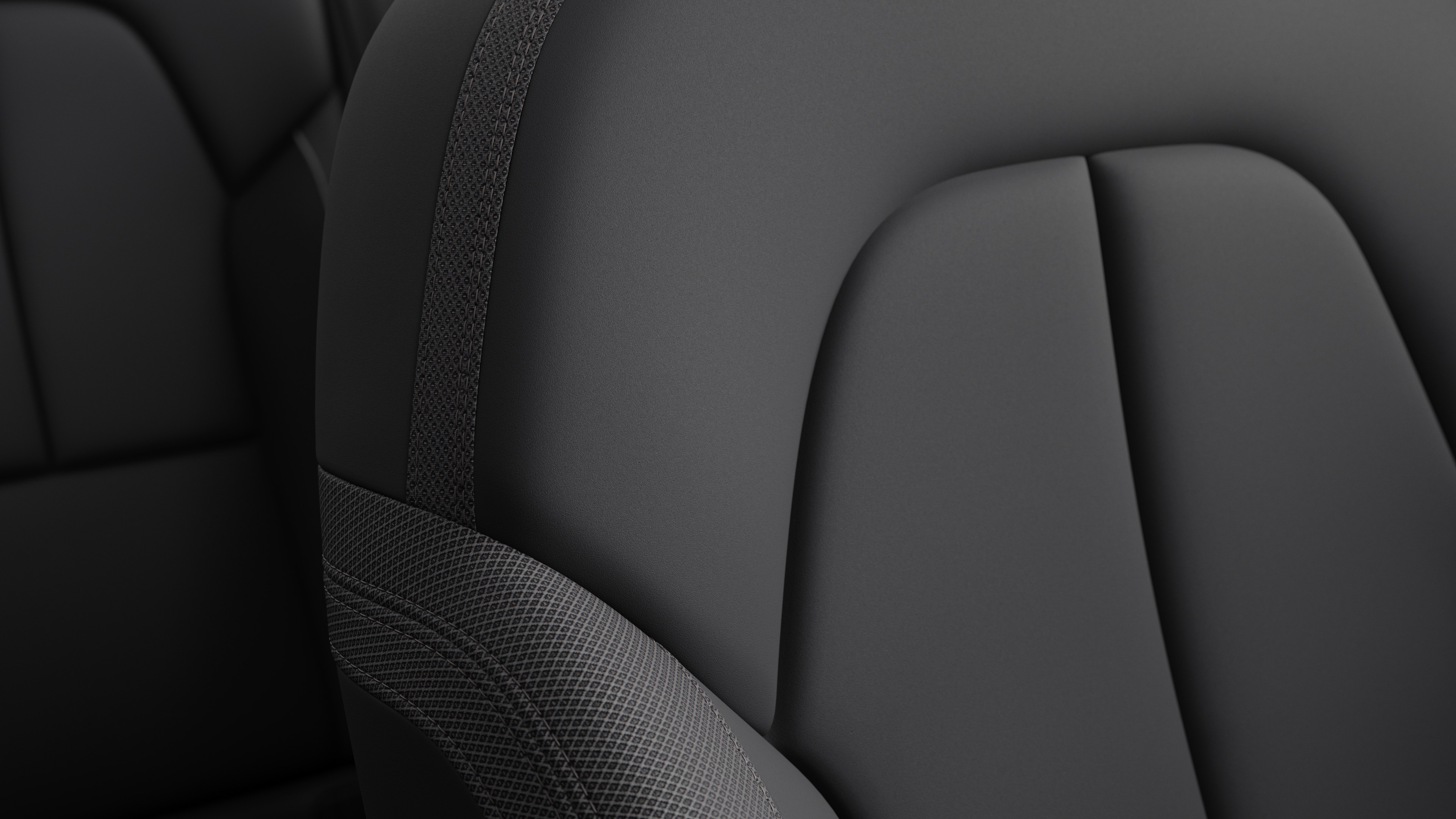 Close-up of Volvo car interior seat detail showing stitching and a small Swedish flag tag.