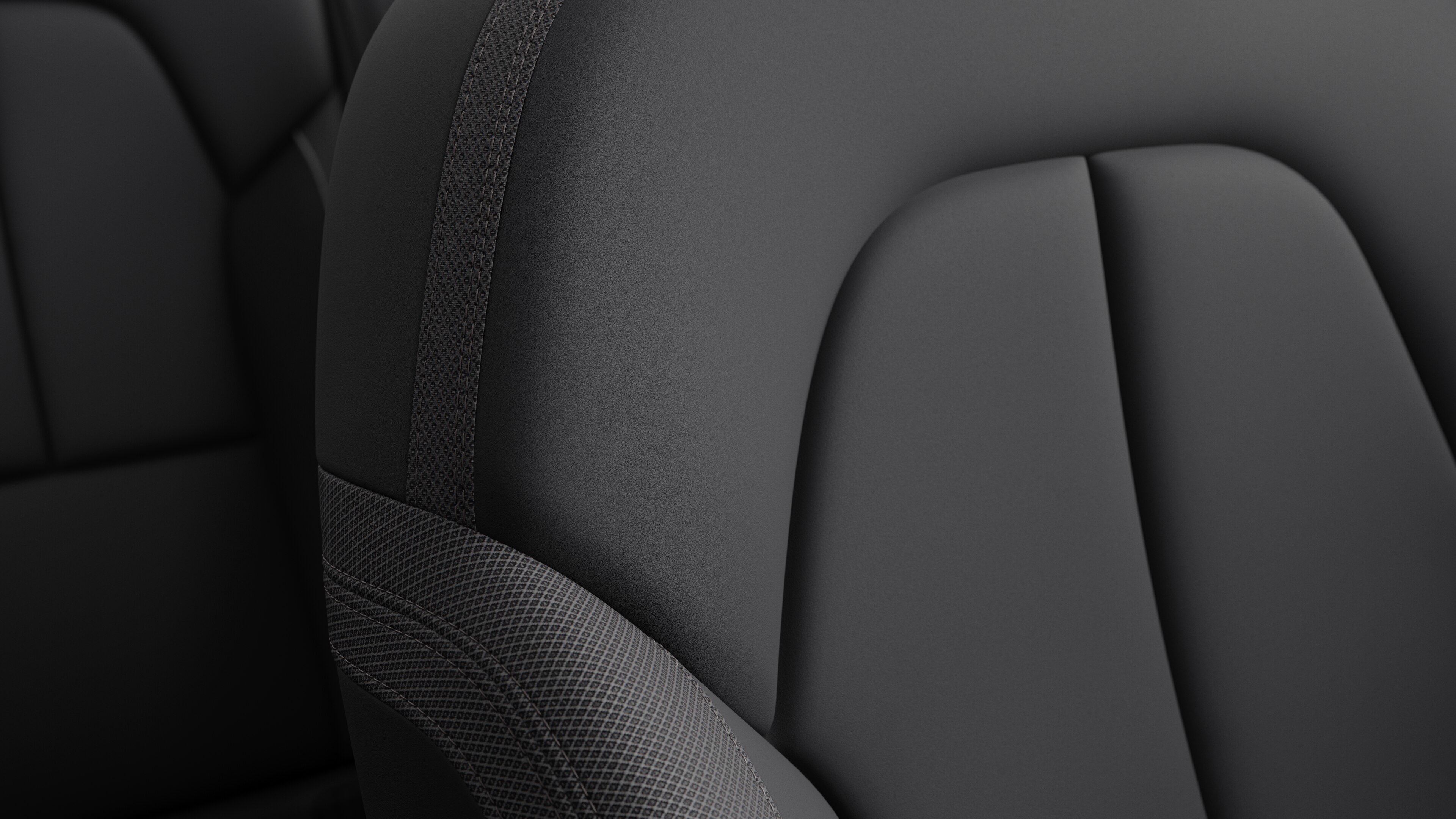 Close-up of Volvo car interior seat detail showing stitching and a small Swedish flag tag.
