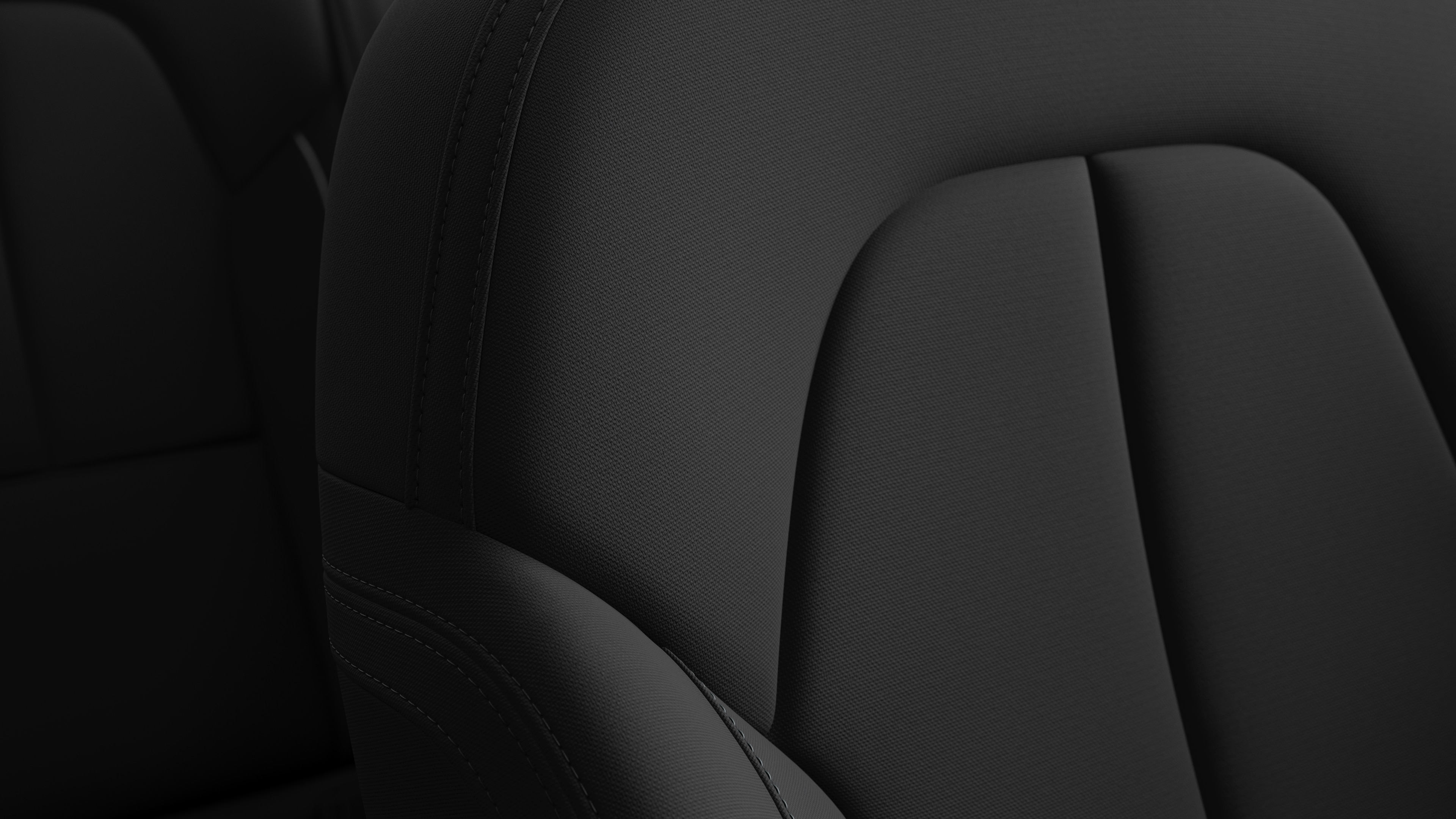 Close-up of Volvo car interior seat detail showing stitching and a small Swedish flag tag.