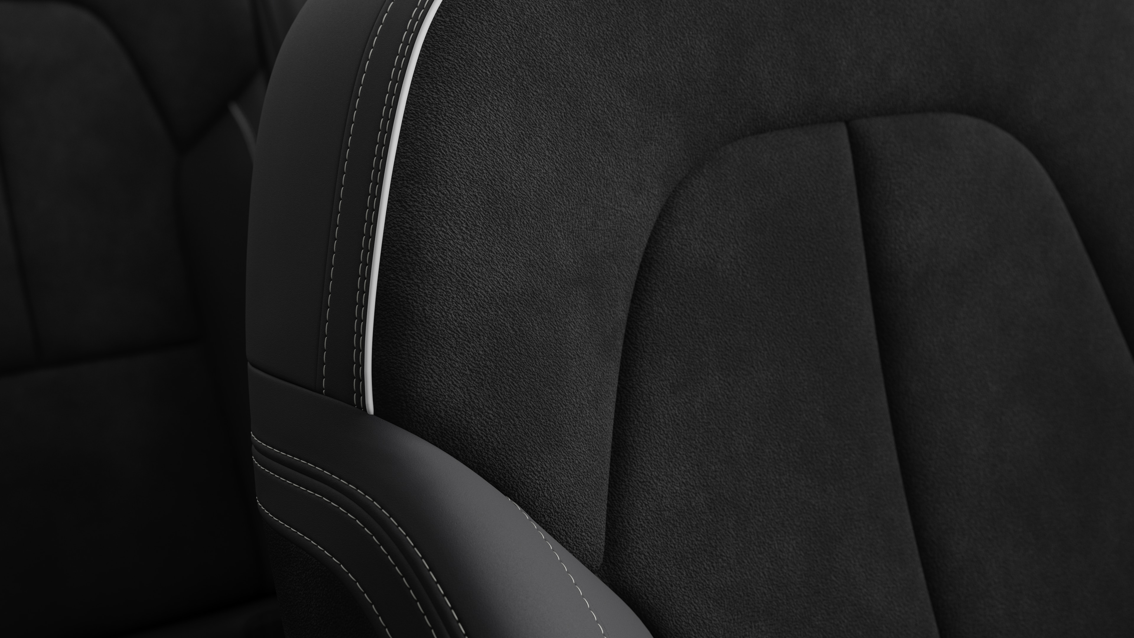 Close-up of Volvo car interior seat detail showing stitching and a small Swedish flag tag.