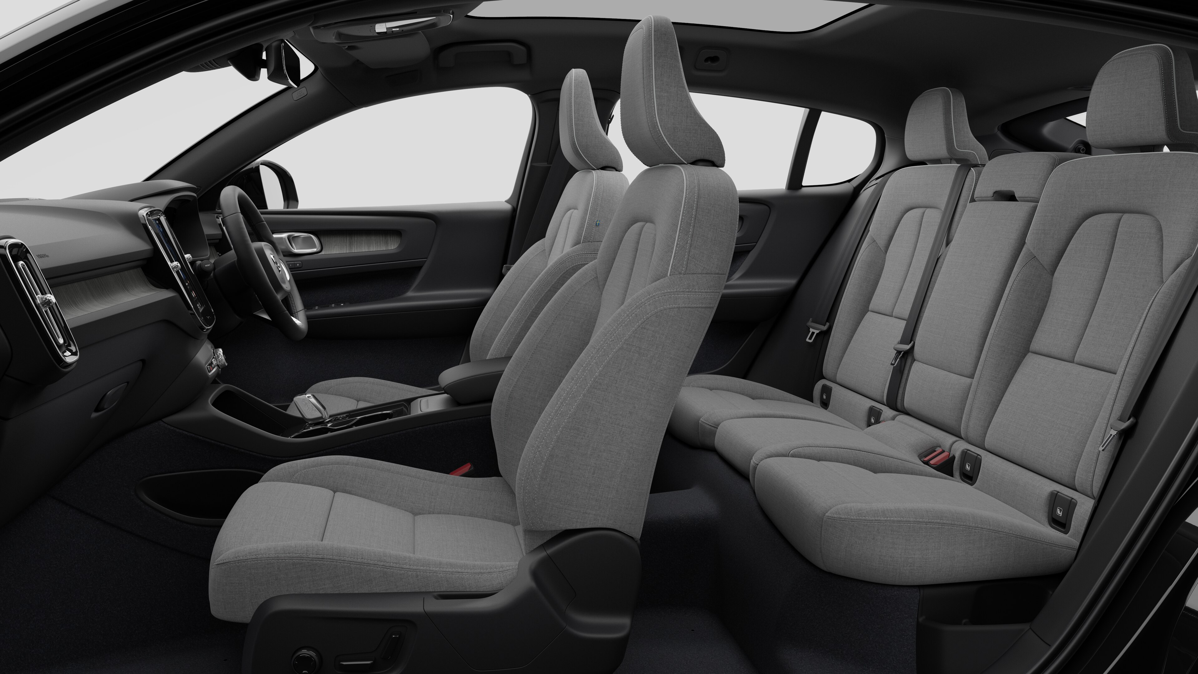 Volvo car interior side view showcasing front seats, rear passenger seats, steering wheel, dashboard, and center console, set against plain studio background.