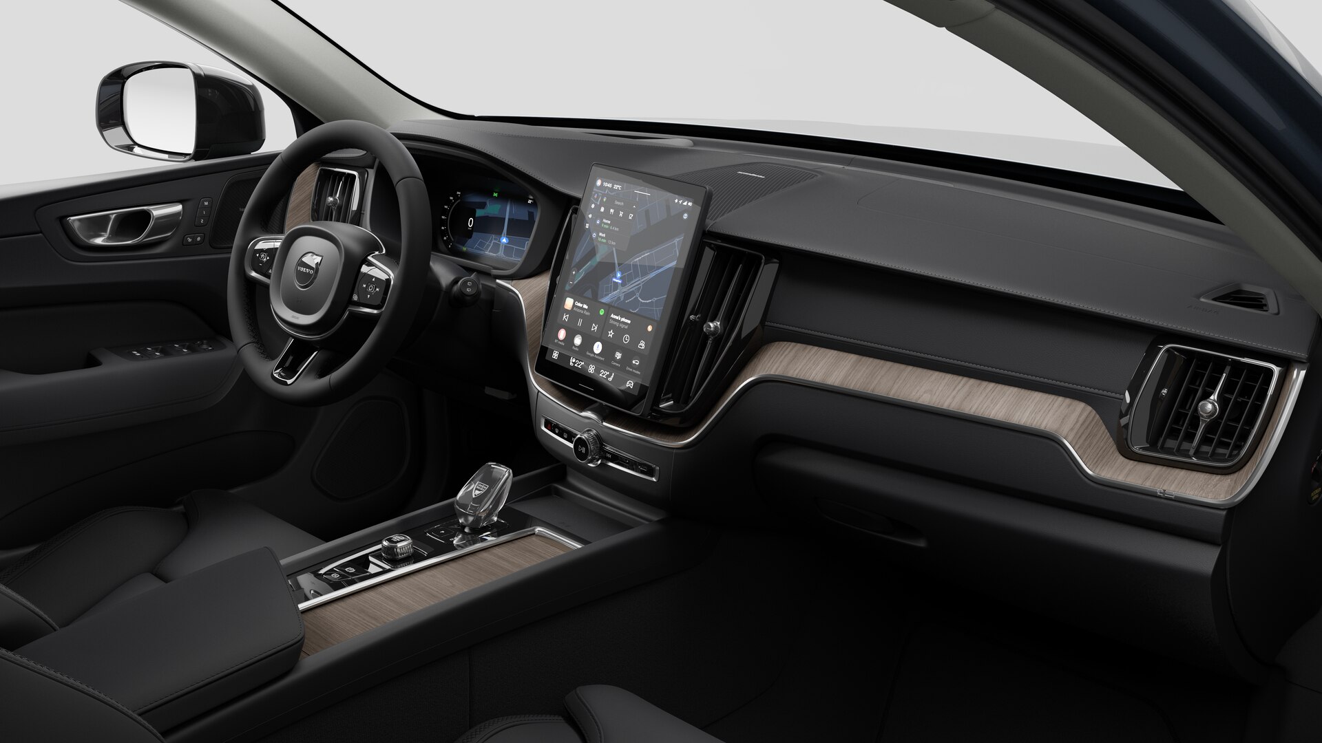 Vue intérieure d’une Volvo montrant le tableau de bord, le volant, la console centrale et l’écran d’affichage numérique sur un fond de studio uni.