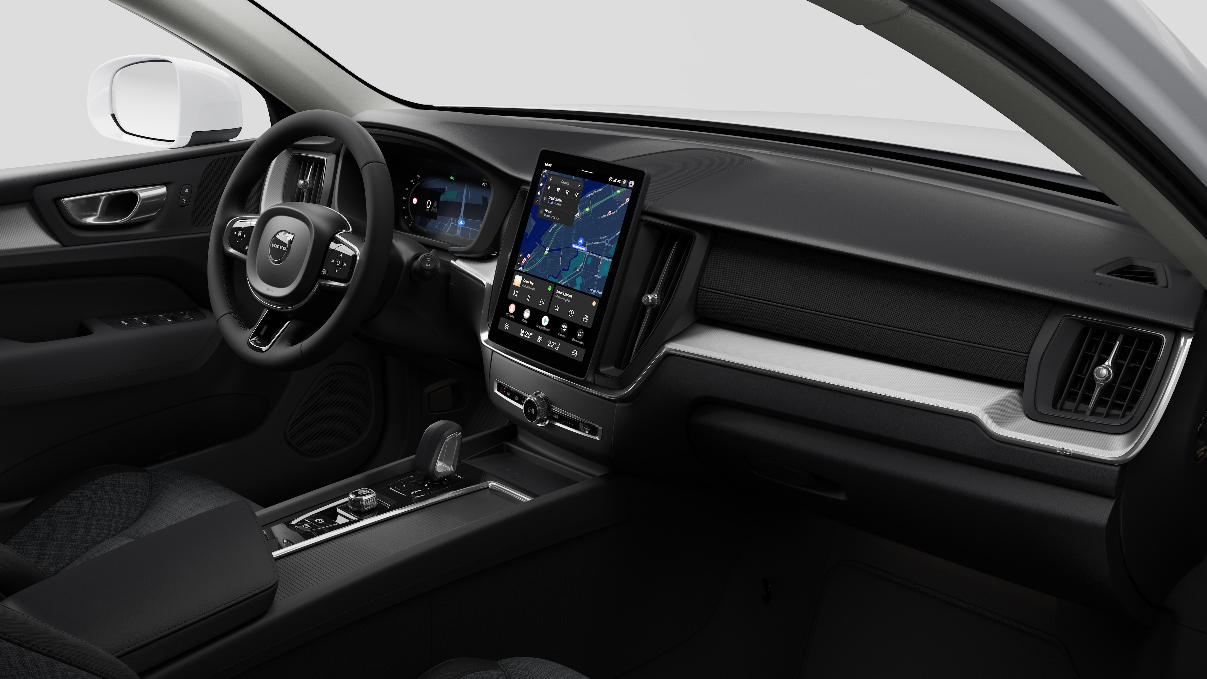 Vista interna di un'auto Volvo che mostra il cruscotto, il volante, la console centrale e lo schermo digitale sullo sfondo di uno studio.