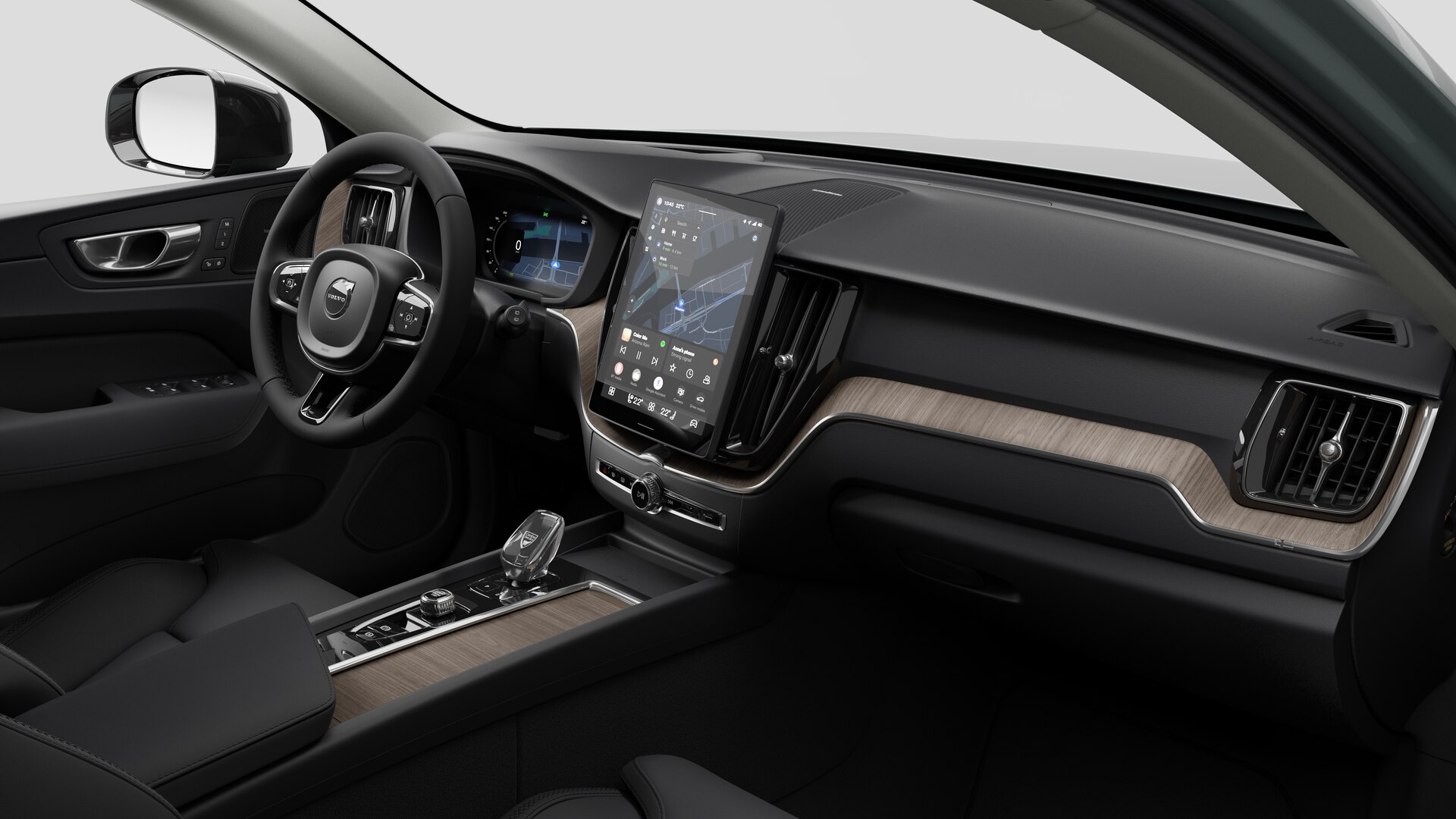 Vue intérieure d’une Volvo montrant le tableau de bord, le volant, la console centrale et l’écran d’affichage numérique sur un fond de studio uni.