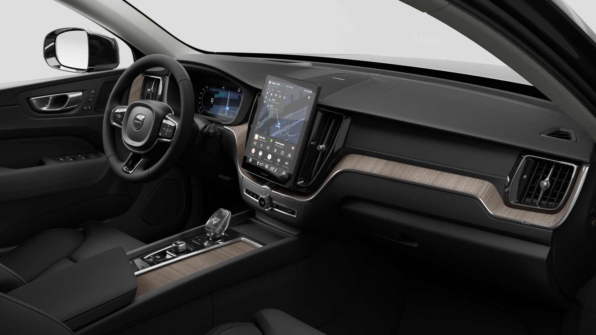 Vue intérieure d’une Volvo montrant le tableau de bord, le volant, la console centrale et l’écran d’affichage numérique sur un fond de studio uni.
