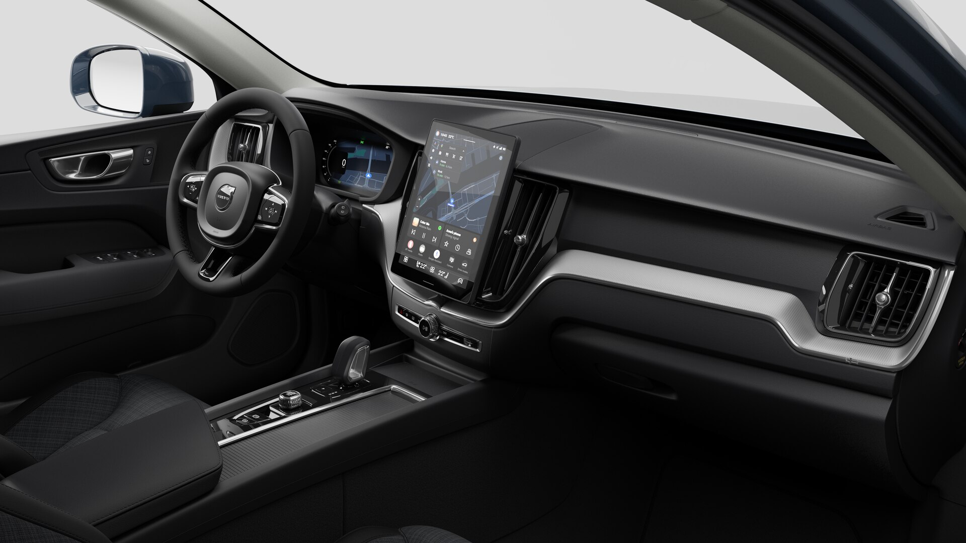 Vue intérieure d’une Volvo montrant le tableau de bord, le volant, la console centrale et l’écran d’affichage numérique sur un fond de studio uni.