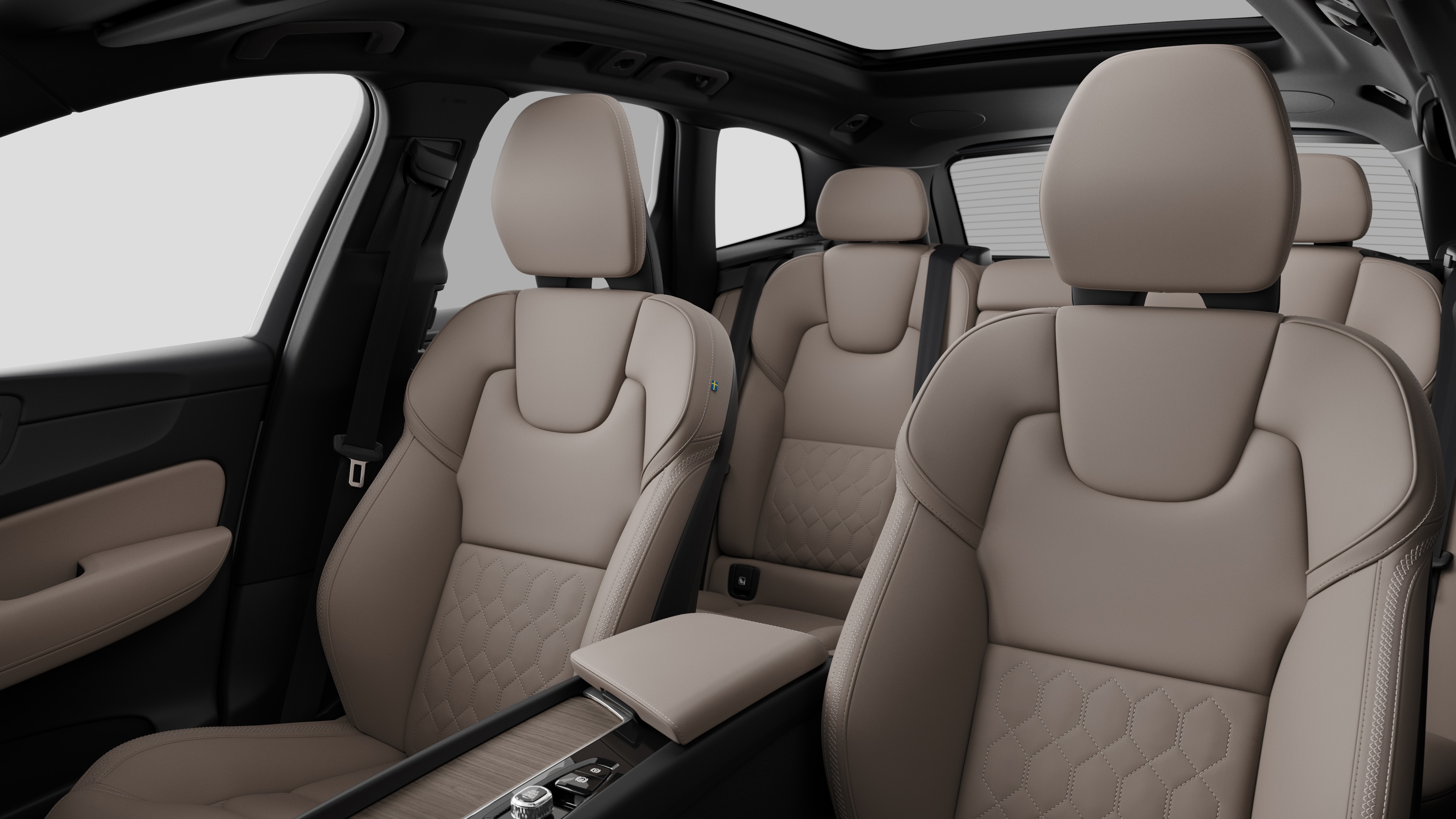Volvo car interior showing rear passenger seats and center console in plain studio background.