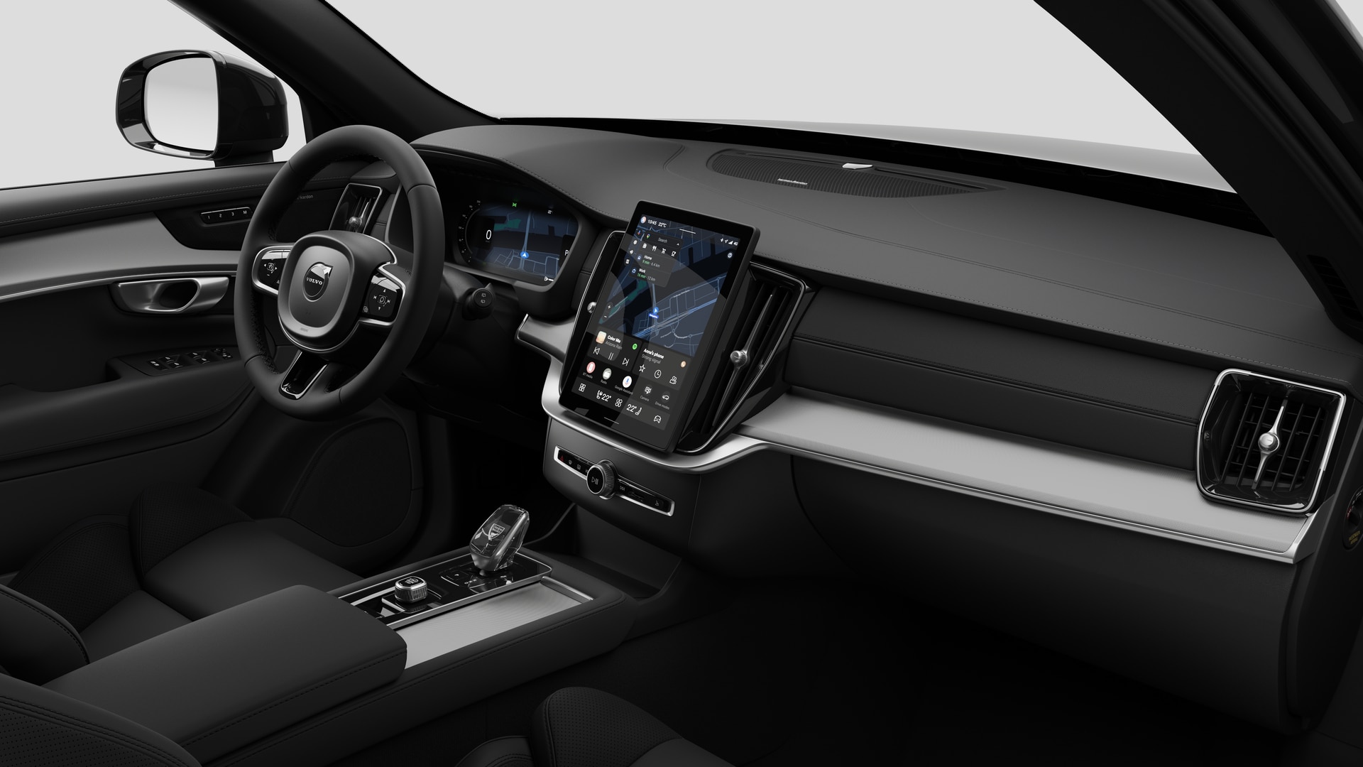 Interior view of a Volvo car showing the dashboard, steering wheel, center console, and digital display screen in a plain studio background.