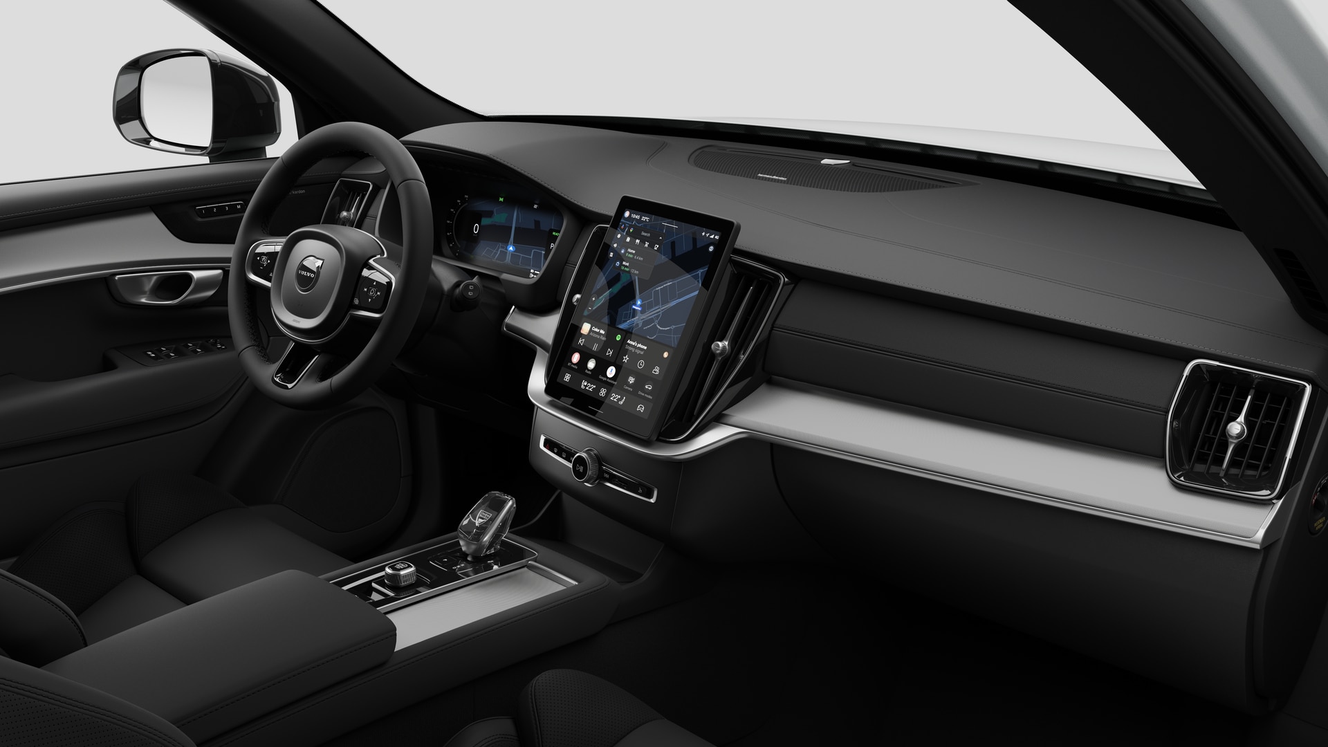 Innenansicht eines Volvo mit Armaturenbrett, Lenkrad, Mittelkonsole und digitalem Bildschirm in einem schlichten Studiohintergrund.