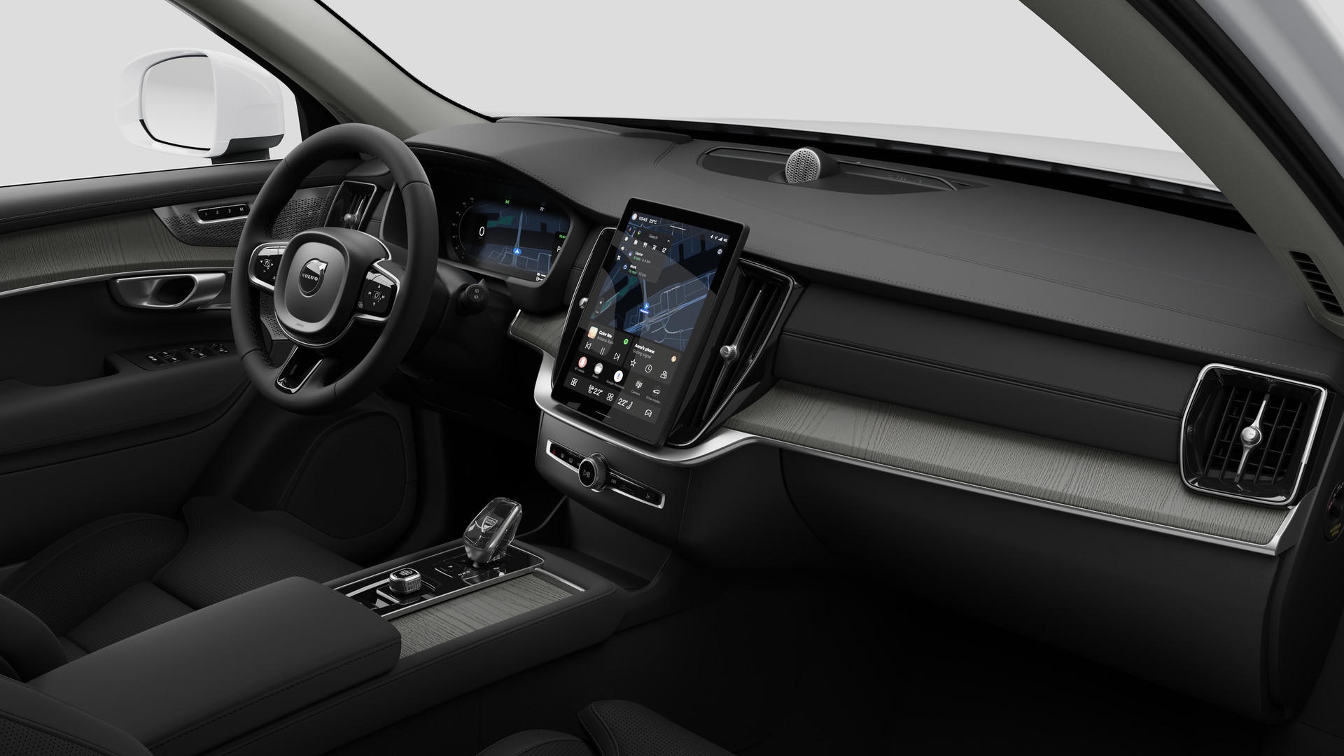 Interiörvy av en Volvobil som visar instrumentbrädan, ratten, mittkonsolen och den digitala skärmen i en vanlig studiobakgrund.