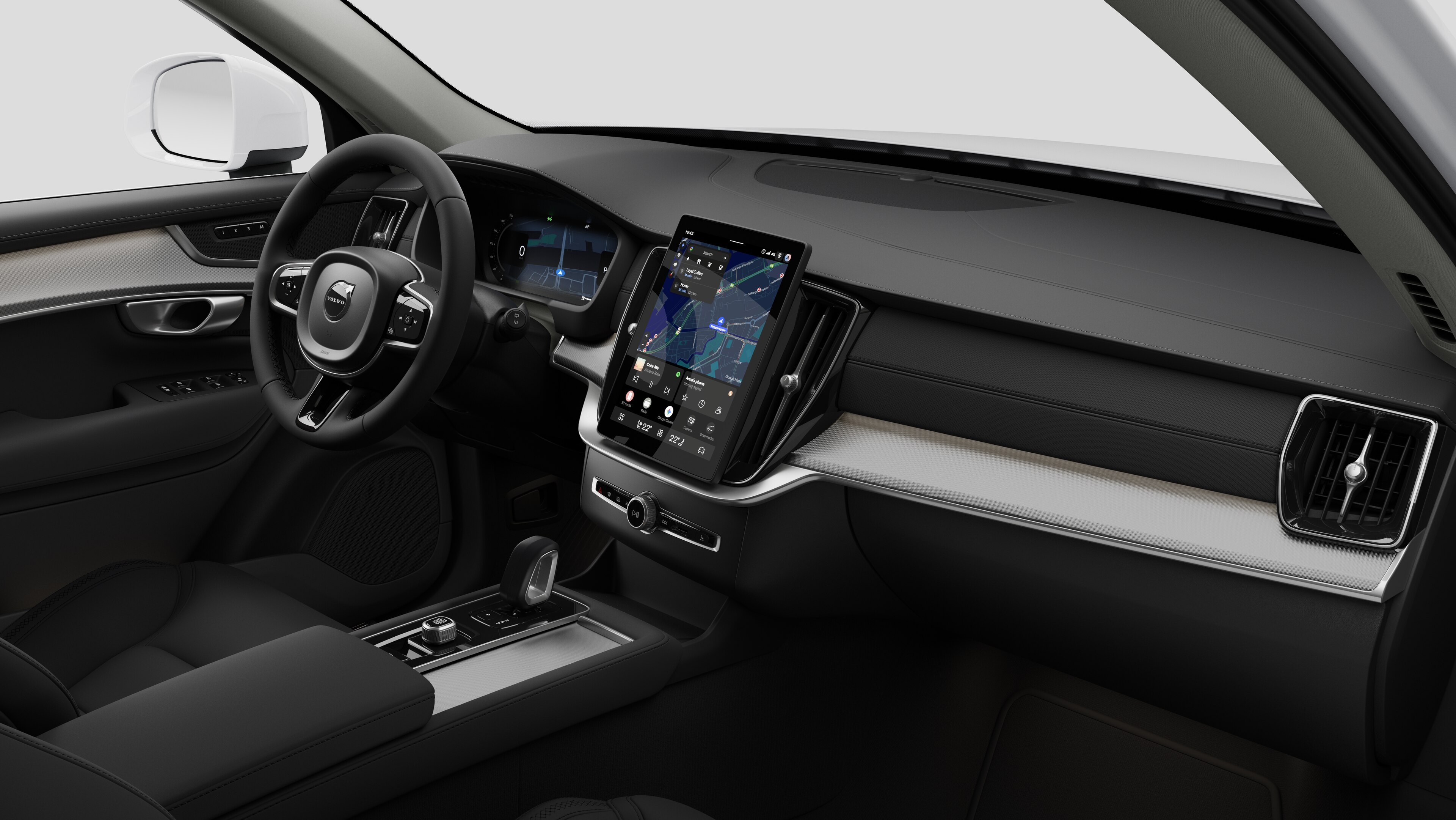 Innenansicht eines Volvo mit Armaturenbrett, Lenkrad, Mittelkonsole und digitalem Bildschirm vor einem schlichten Studiohintergrund.