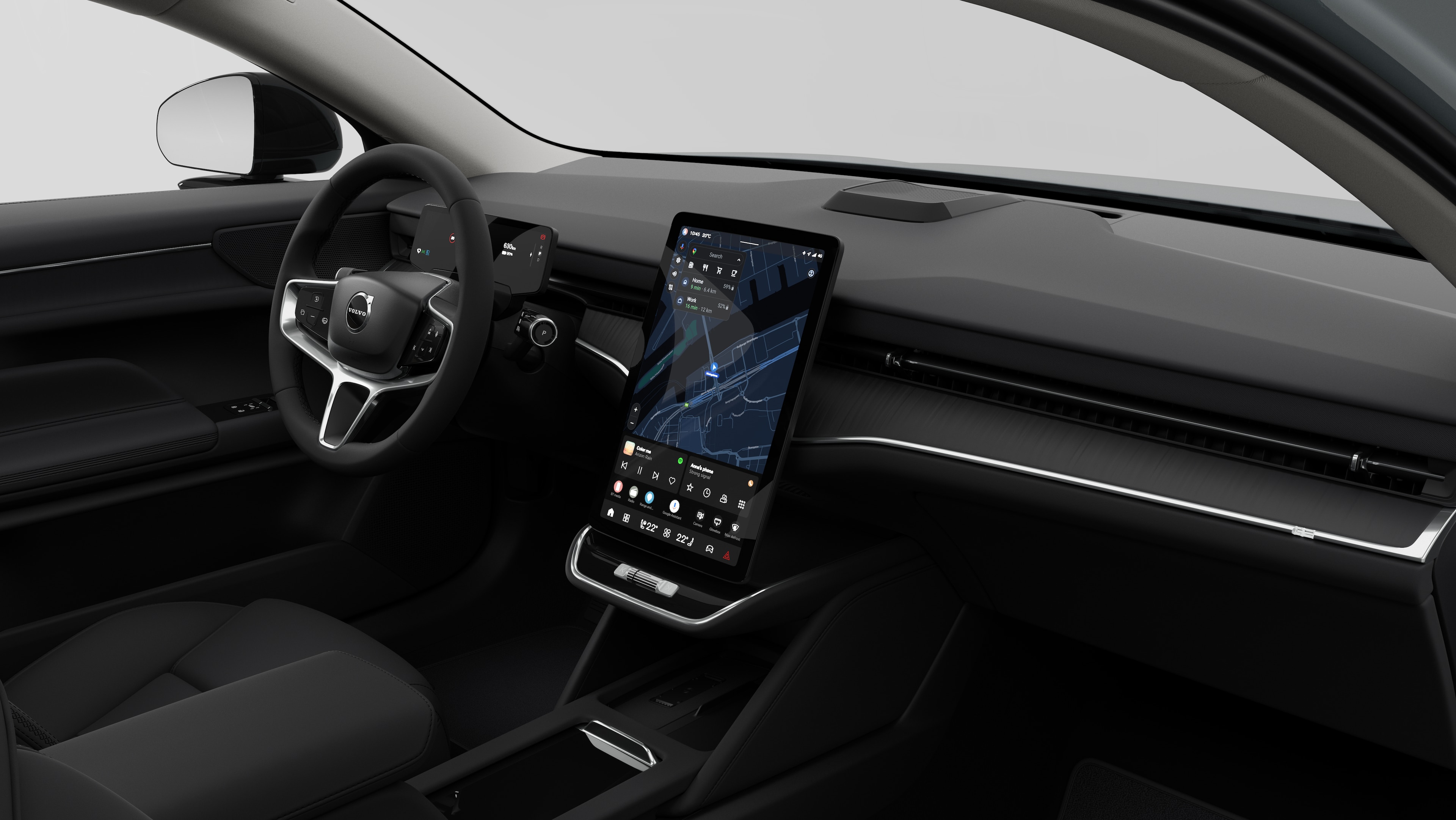 Interior view of a Volvo car showing the dashboard, steering wheel, center console, and digital display screen in a plain studio background.