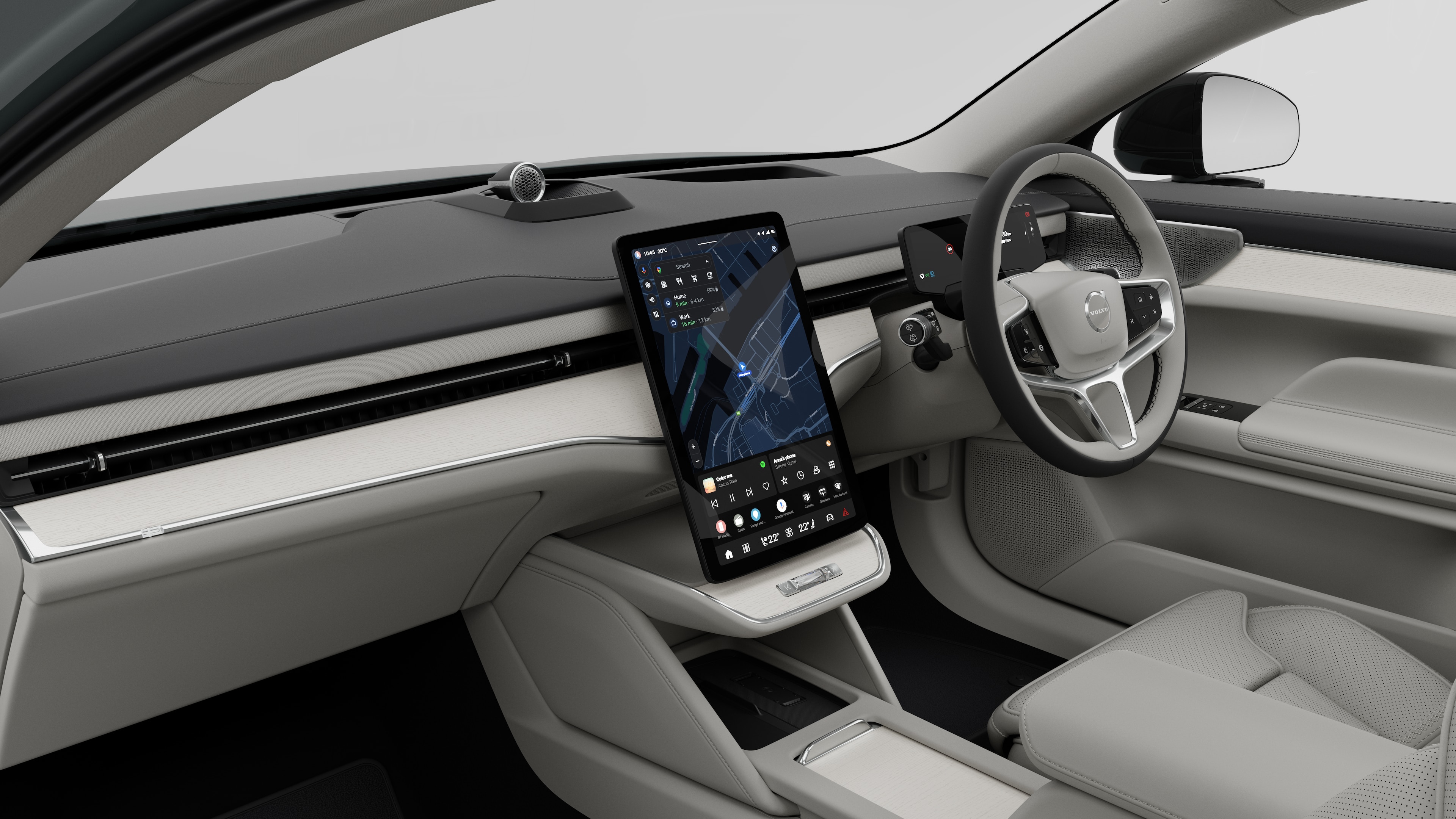 Interior view of a Volvo car showing the dashboard, steering wheel, center console, and digital display screen in a plain studio background.