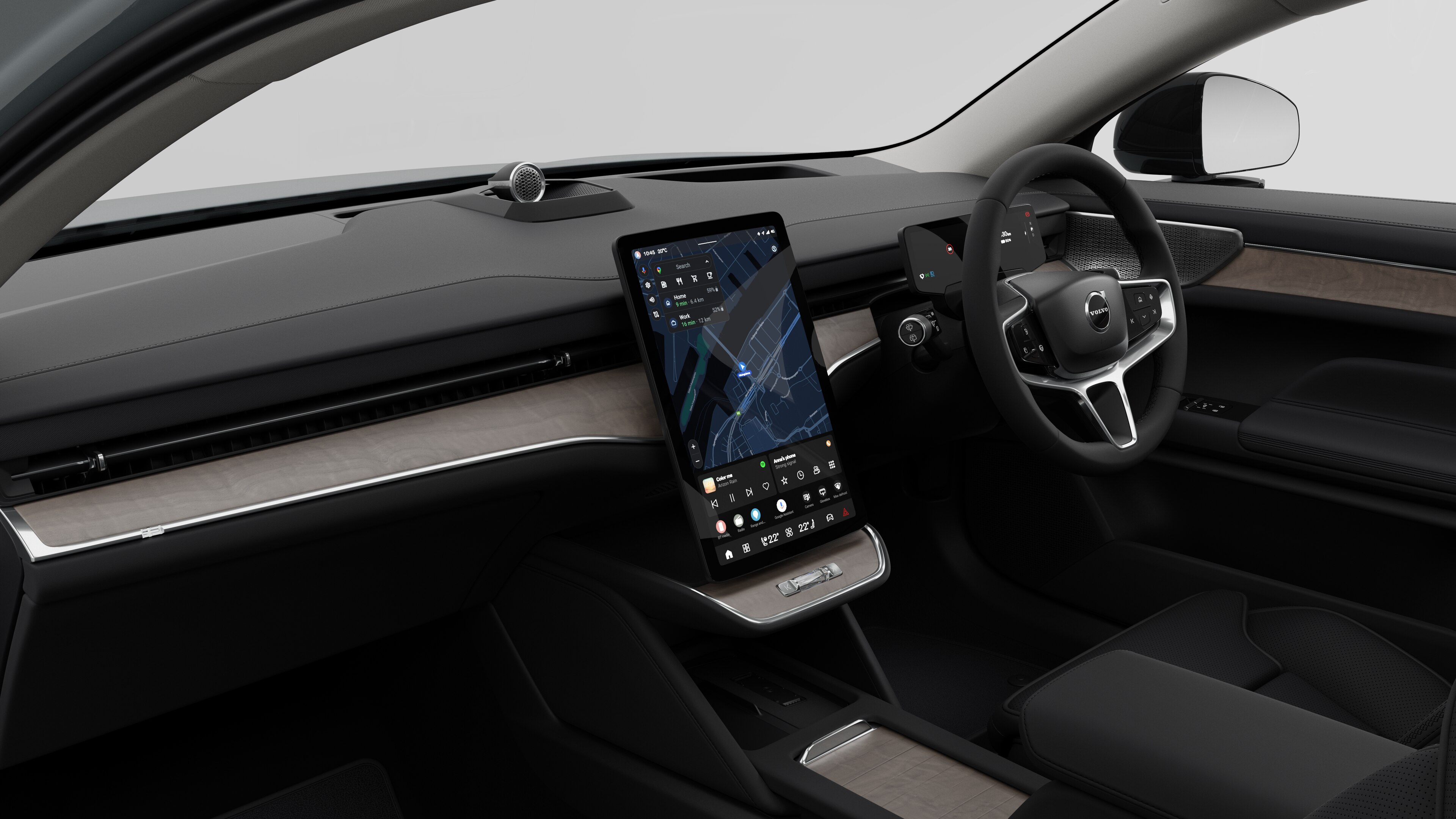 Interior view of a Volvo car showing the dashboard, steering wheel, center console, and digital display screen in a plain studio background.