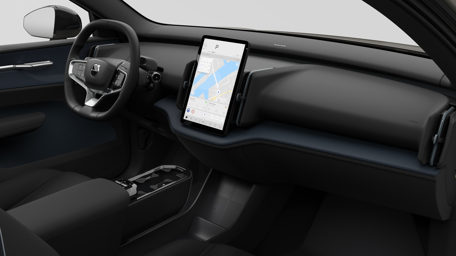 Interior view of a Volvo car showing the dashboard, steering wheel, center console, and digital display screen in a plain studio background.