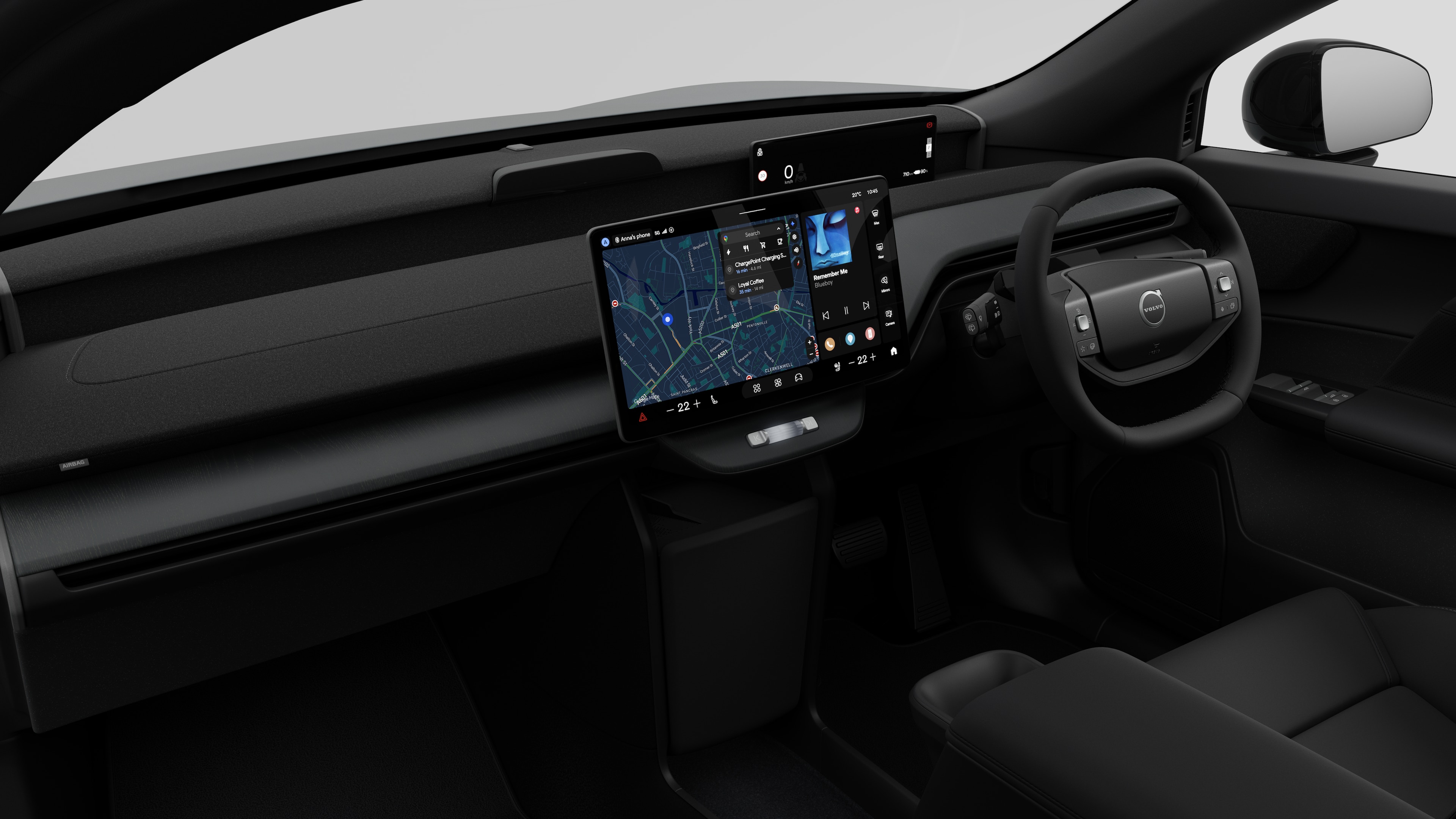 Interior view of a Volvo car showing the dashboard, steering wheel, center console, and digital display screen in a plain studio background.