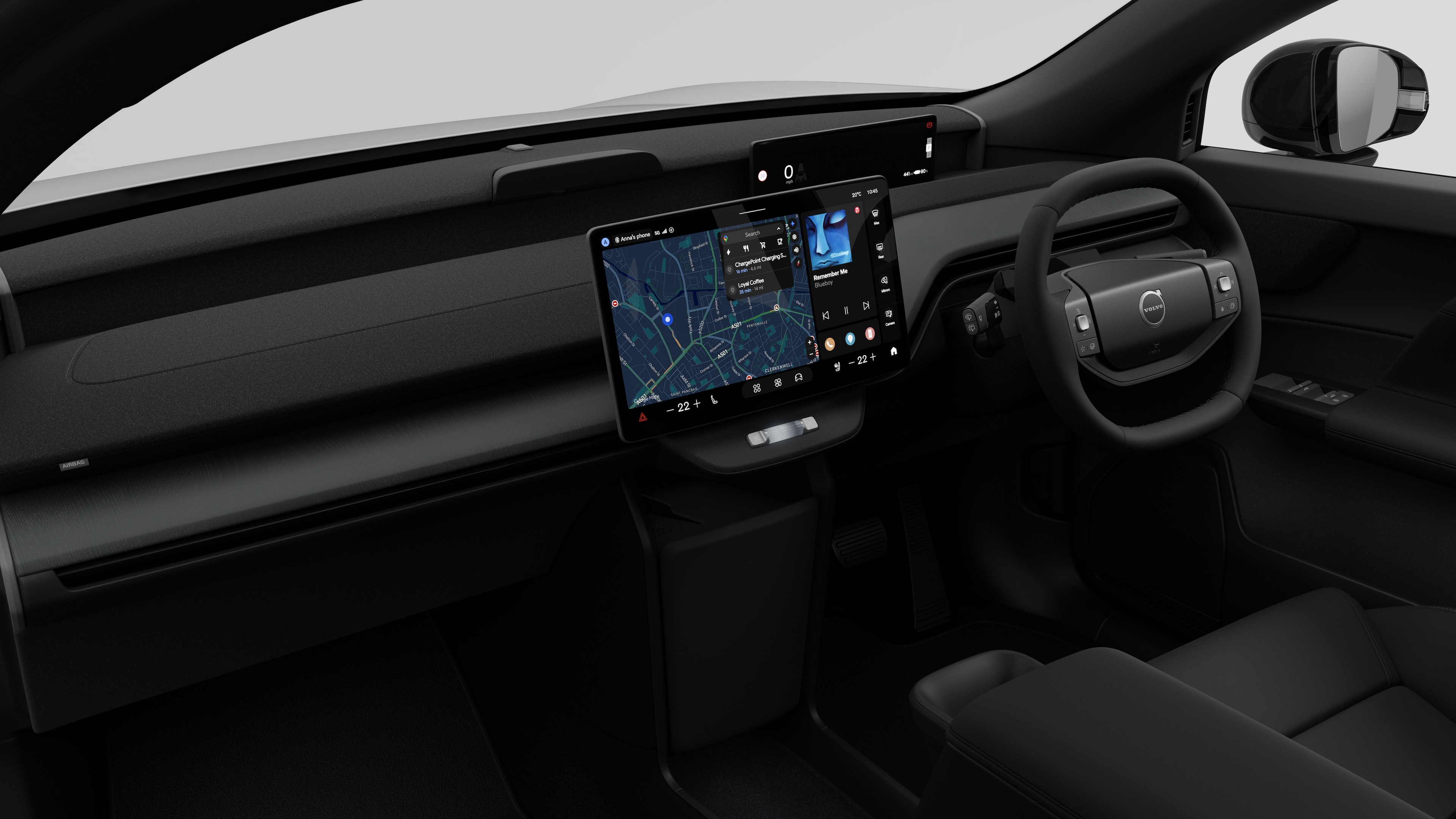 Interior view of a Volvo car showing the dashboard, steering wheel, centre console, and digital display screen in a plain studio background.