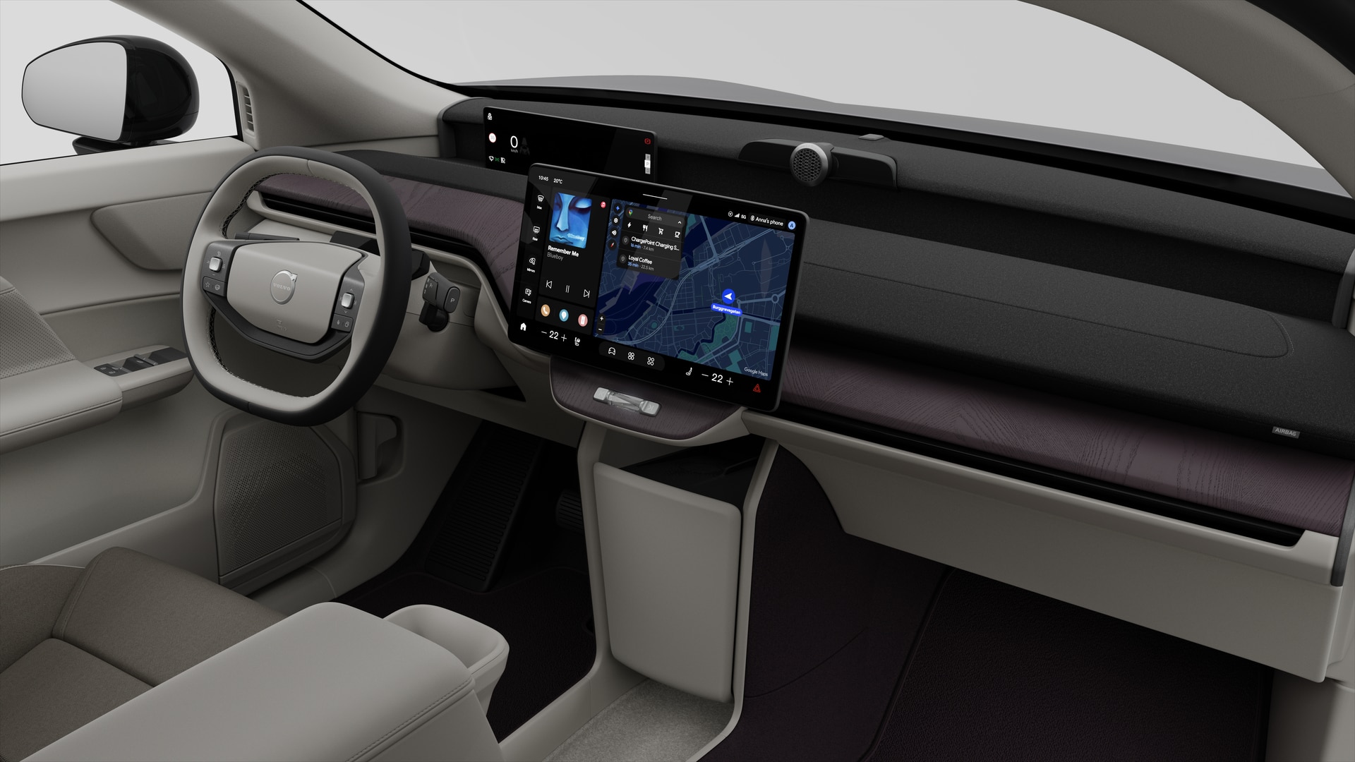 Vue intérieure d’une Volvo montrant le tableau de bord, le volant, la console centrale et l’écran d’affichage numérique sur un fond de studio uni.