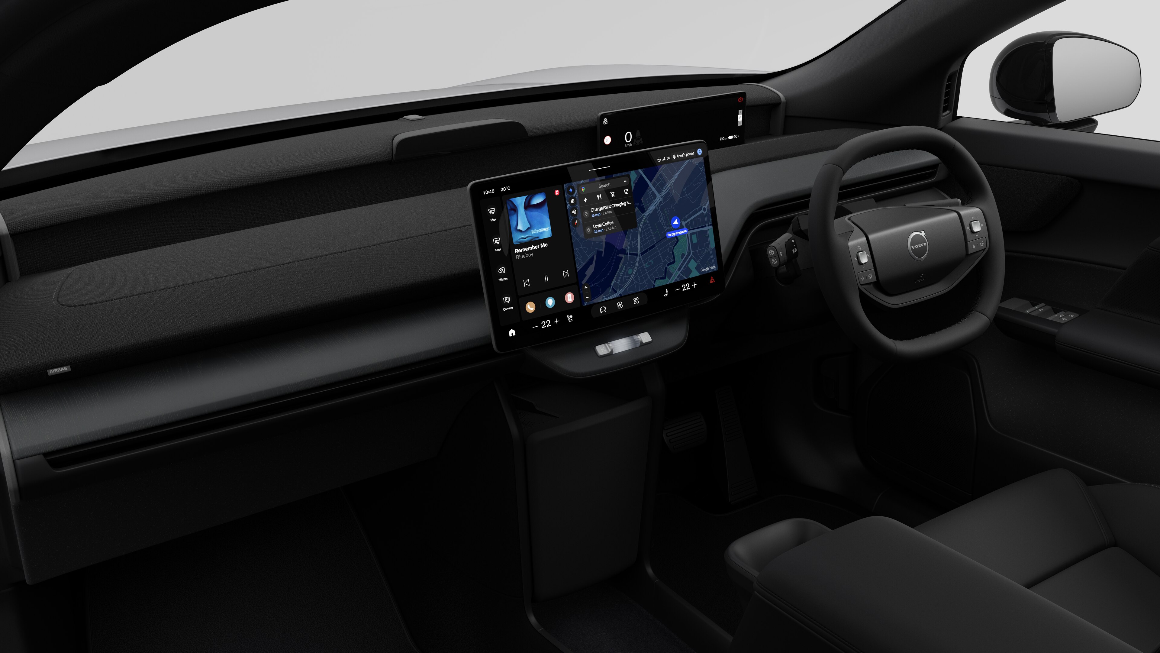 Interior view of a Volvo car showing the dashboard, steering wheel, center console, and digital display screen in a plain studio background.